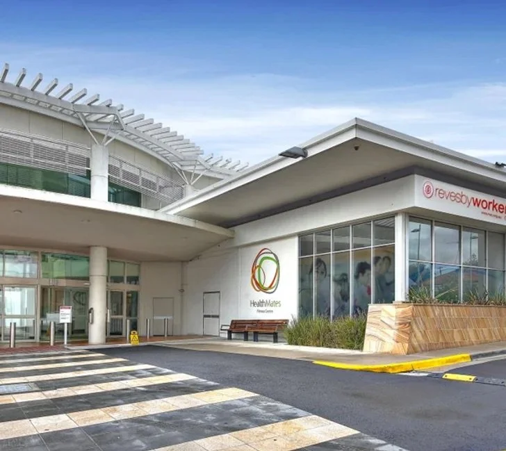 Exterior view of Health Mates Fitness Centre at Revesby Workers Club with modern architecture and large glass windows.