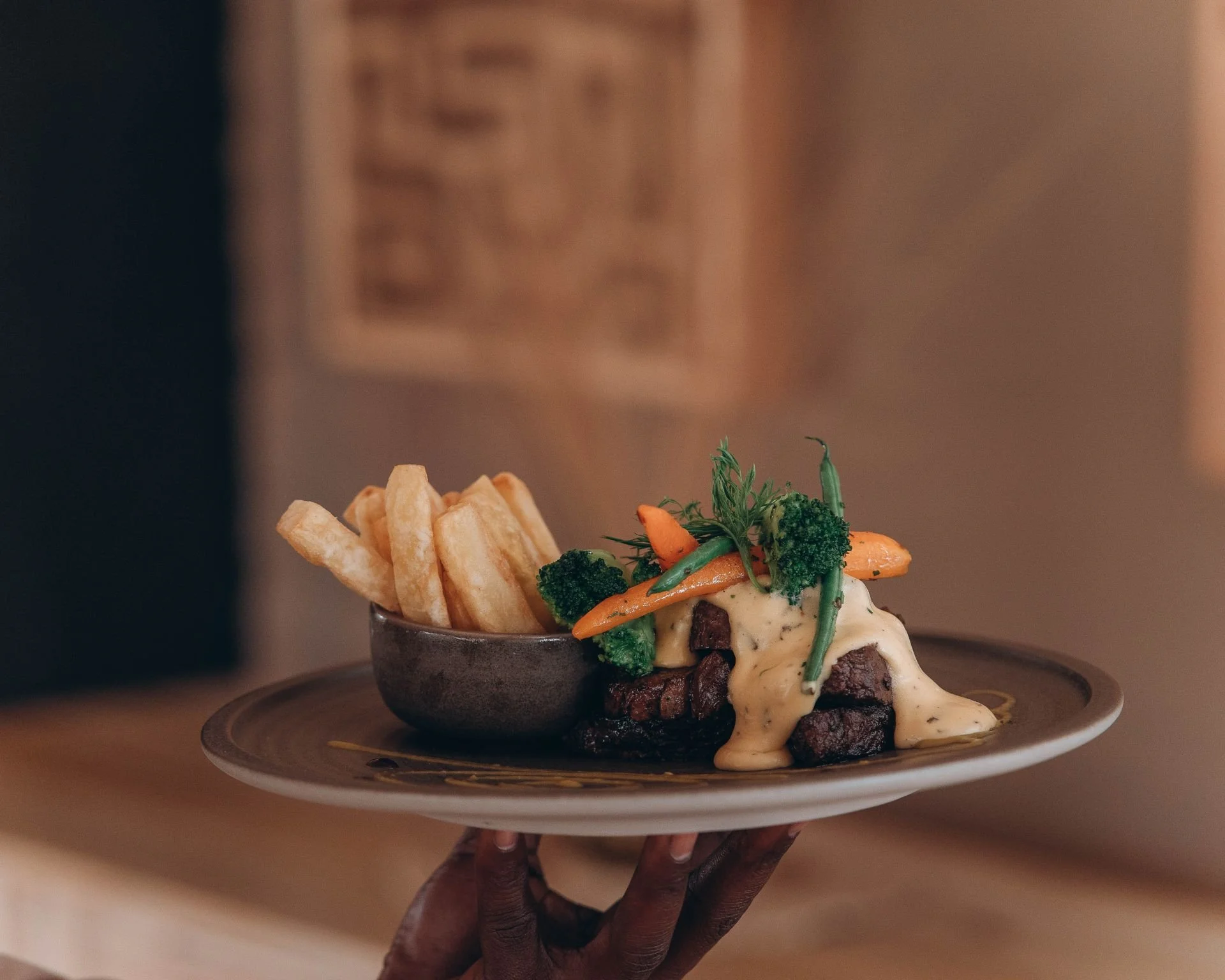 Luxury safari dining table setup with wine glasses and elegant tableware overlooking the African wilderness for a fine bush experience.