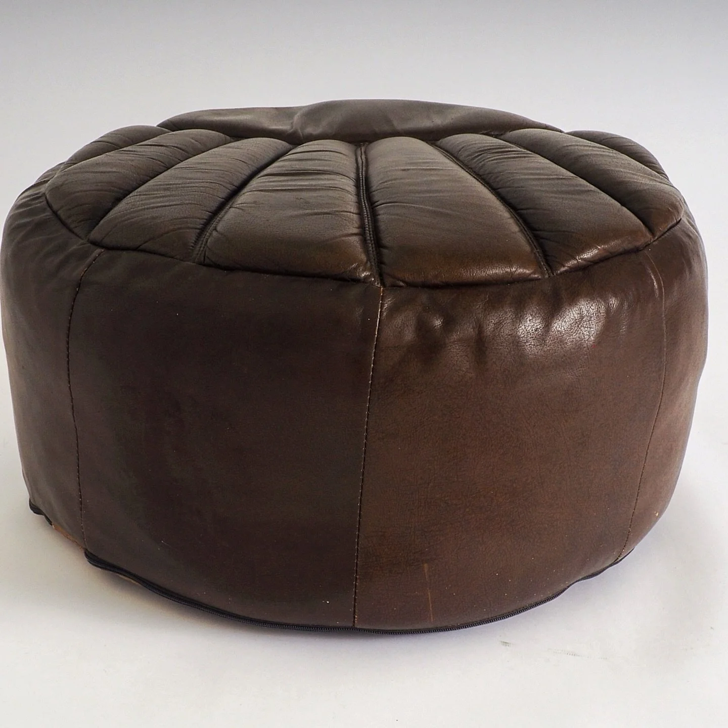 Vintage Leather pouf

This vintage leather pouf is a striking piece that balances mid-century character with a soft, organic silhouette. 
The most distinctive feature is the fan-shaped or shell-style channel tufting on the top. 
The leather panels ra