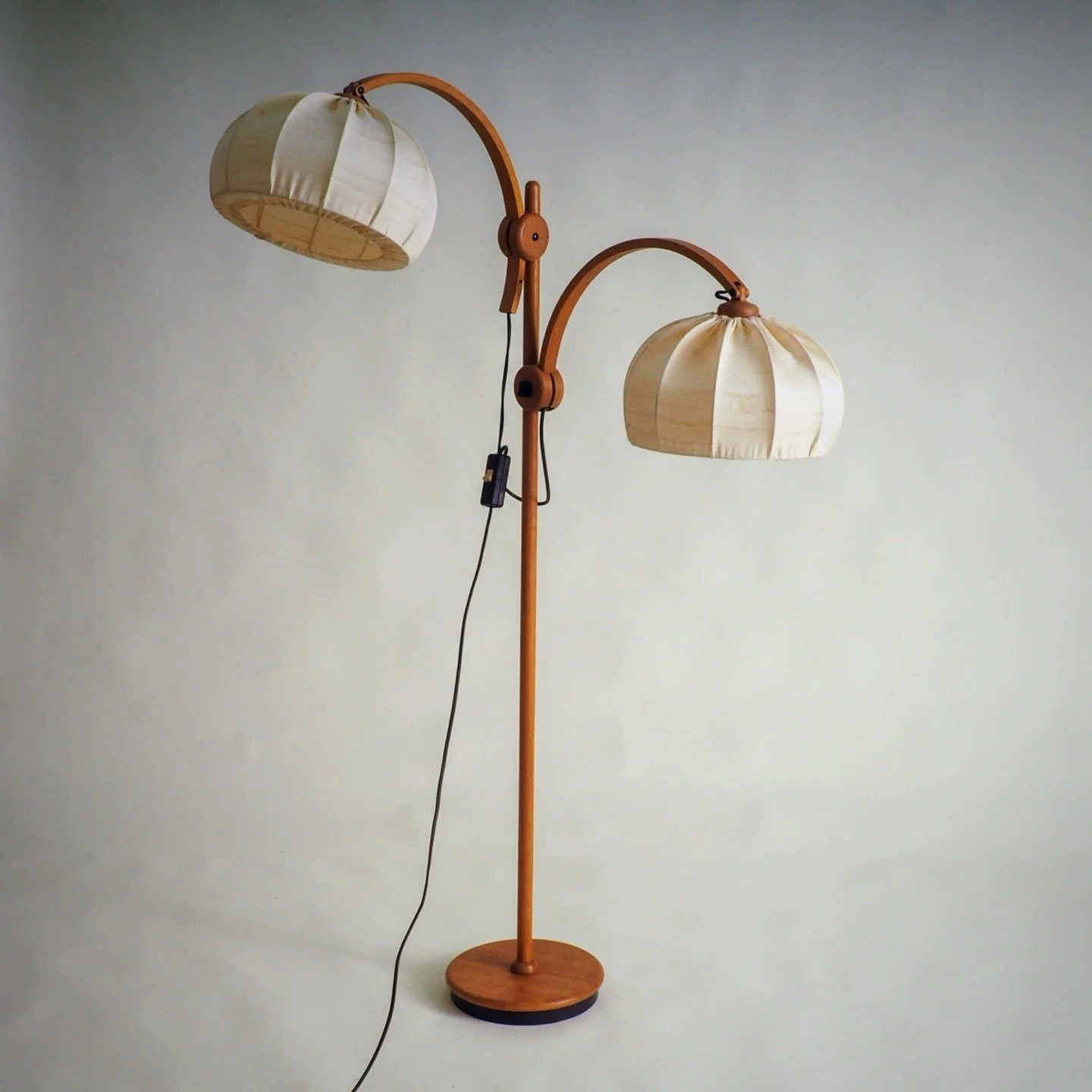 SOLD but too good not to share

Teak Floor Lamp with 2 shades by Domus

This is an elegant teak floor lamp by Domus from the 1970. 
It features a sculptural solid teak stem and a matching round base. The lamp is fitted with two offwhite fabric lampsh
