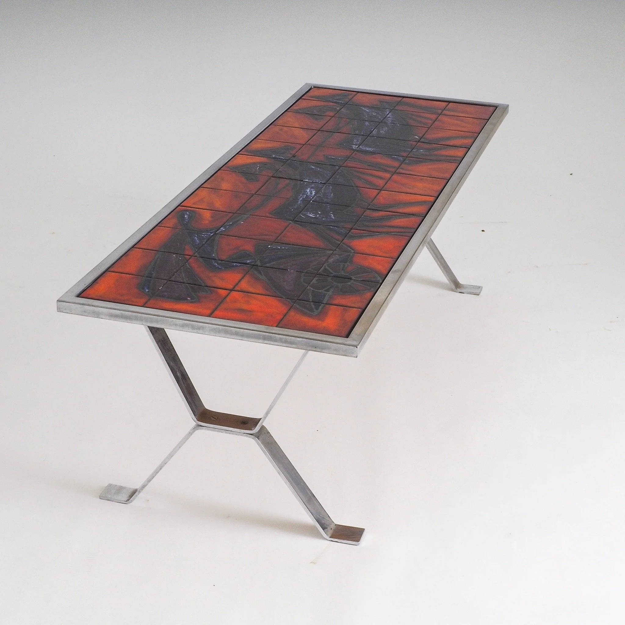(SOLD)

Mid-Century Modern Tiled Coffee Table by Bayer

This authentic Bayer coffee table features a hand-glazed ceramic top in perfect condition, showcasing a vibrant "lava" glaze and Chariot/Horse design.

The ceramic top is supported by 