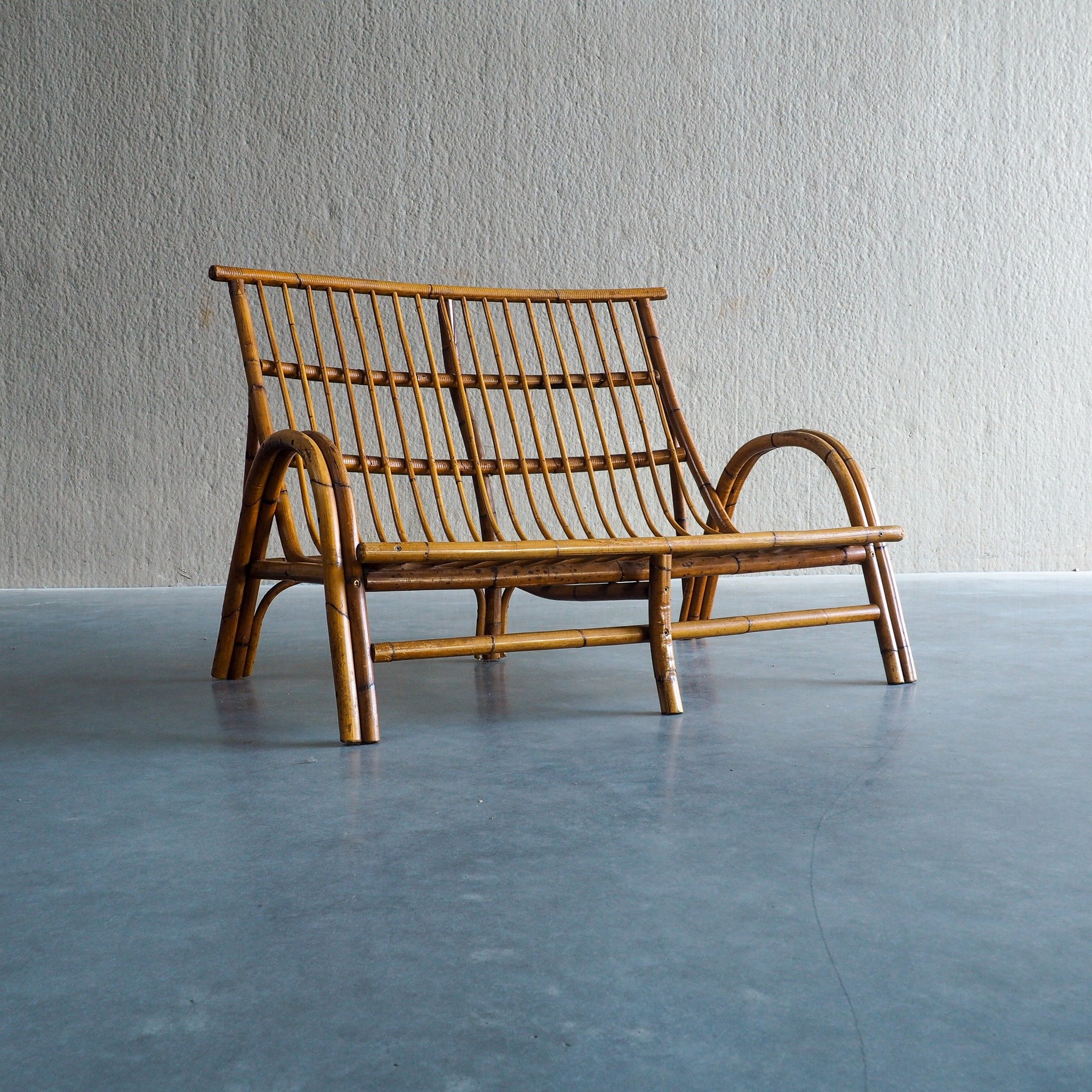Mid-Century Rattan &amp; Bamboo Two-Seater Lounge Sofa

Vintage mid-century 2-seater rattan and bamboo bench featuring smooth bentwood armrests and a comfortable slatted seat. Perfect for bringing natural warmth and bohemian elegance into any modern 