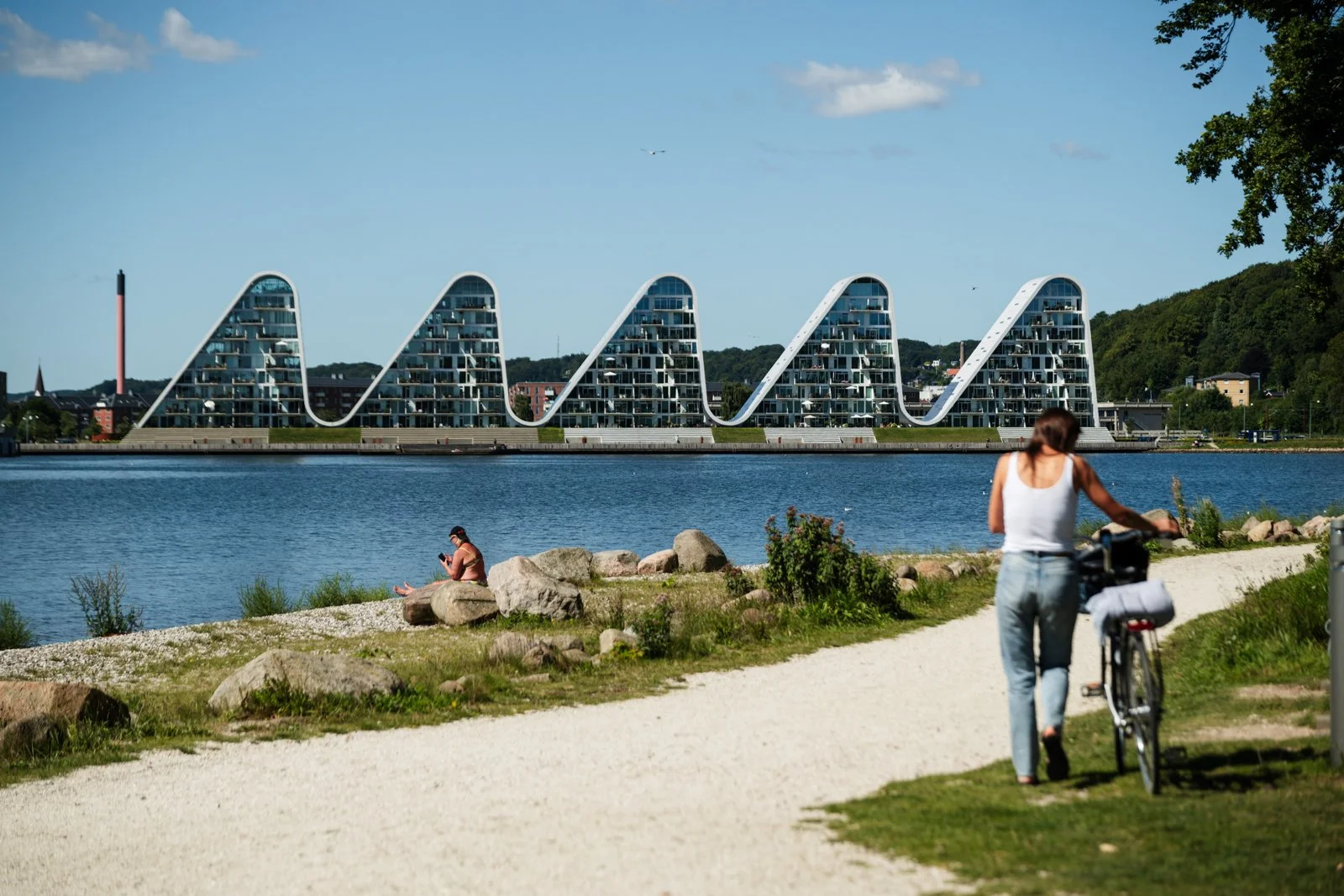 Cycling and casual rest, showcasing the integration of the architectural landmark into the daily life of Vejle residents.
