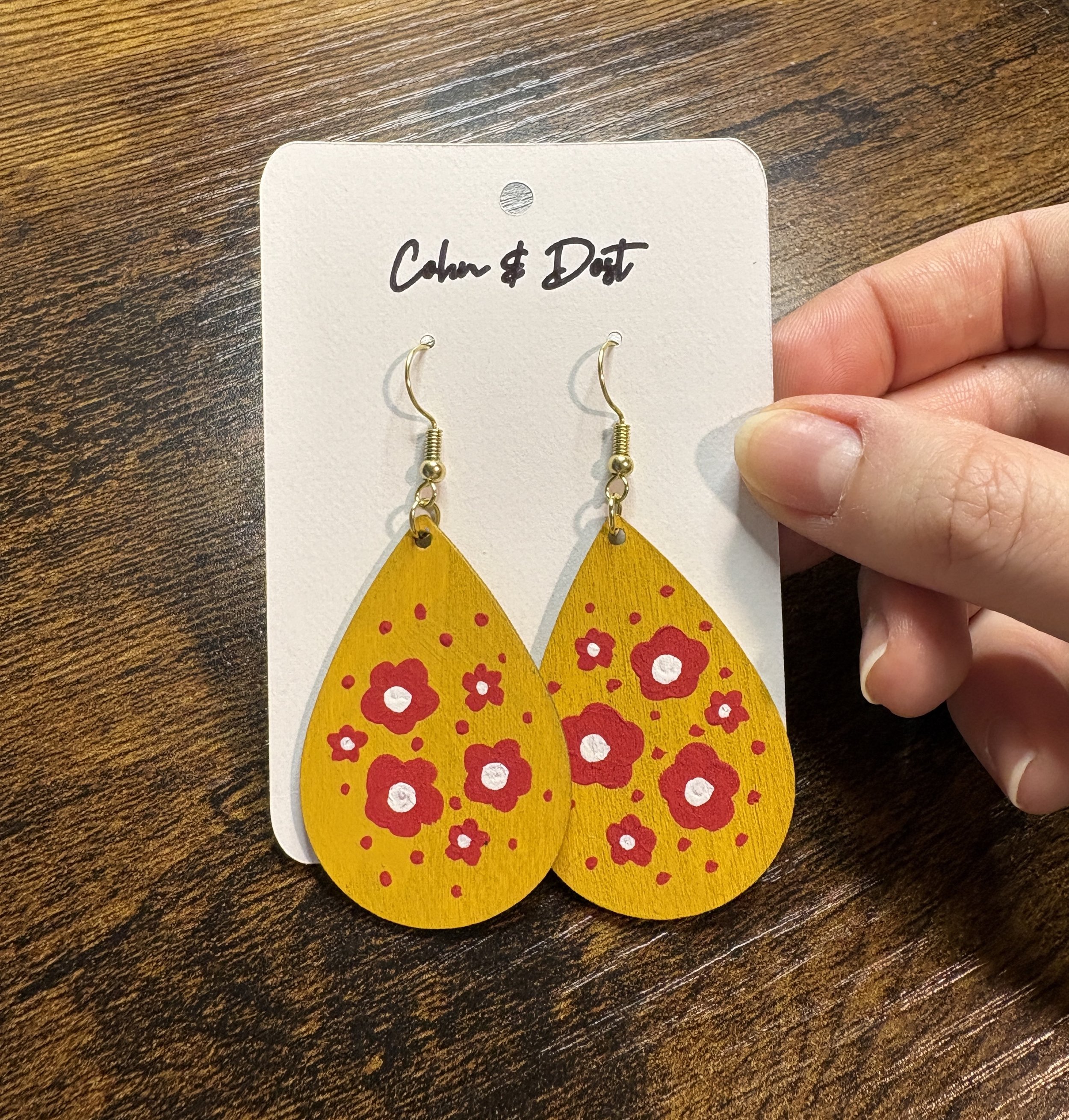 yellow teardrop earrings holding.JPG