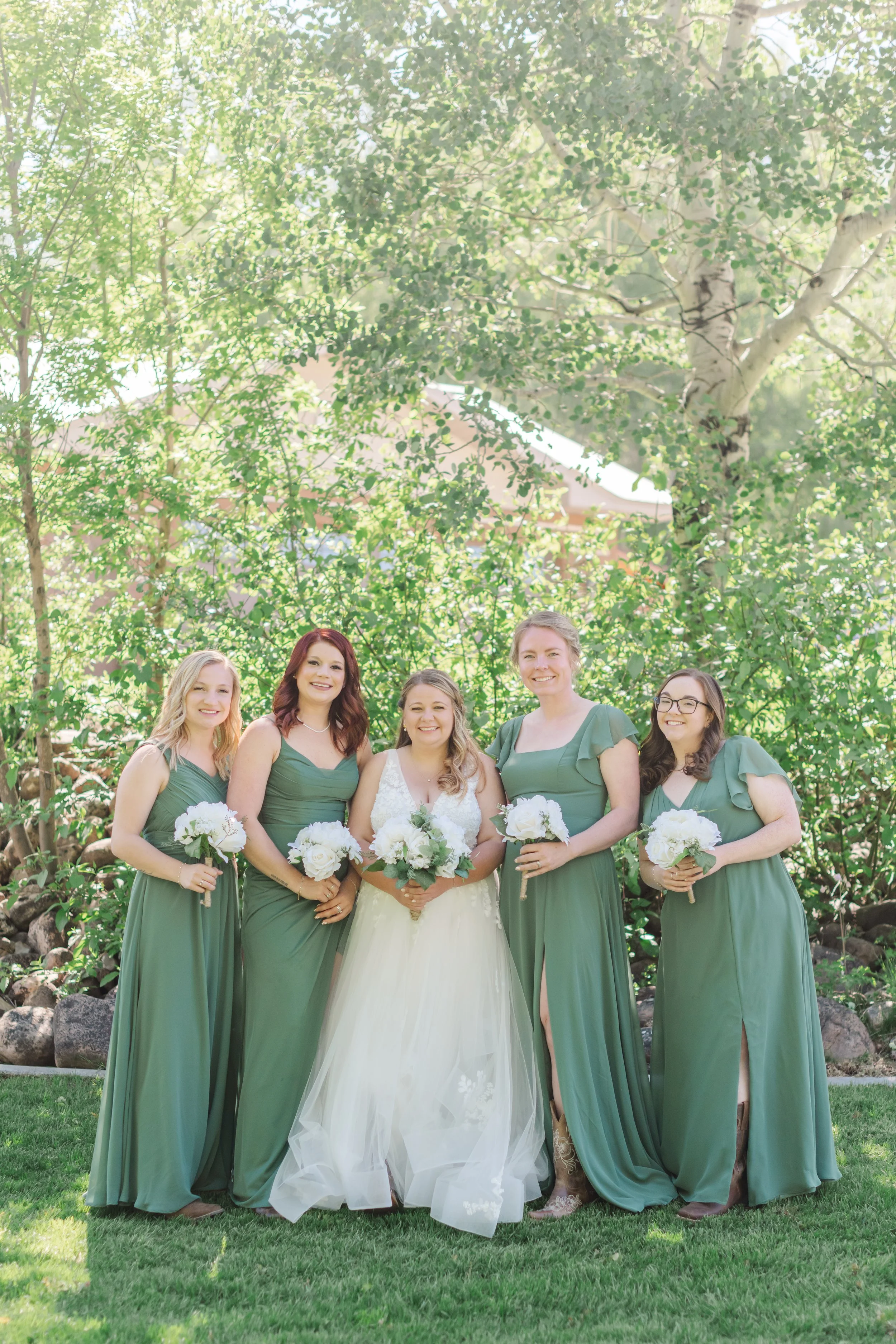  Star Valley Lodge Bridal Party posing in front of trees. 