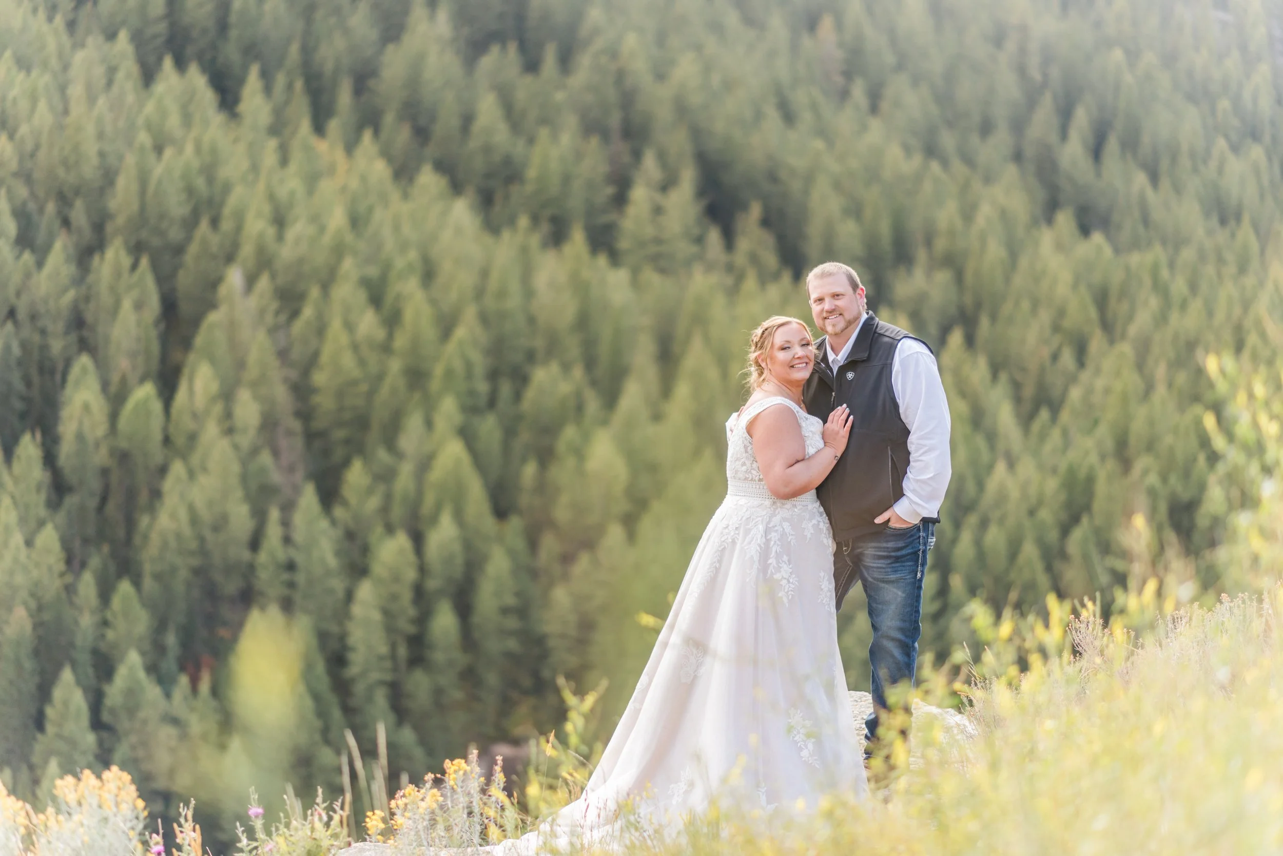 Couple Posing in front of a forest near the Grand Tetons