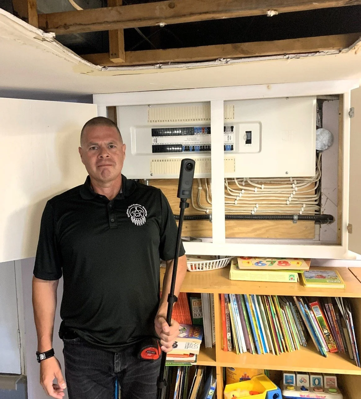 Tim Maness, Technical Services Manager, SFNS holding the 3D camera during a review of a building.