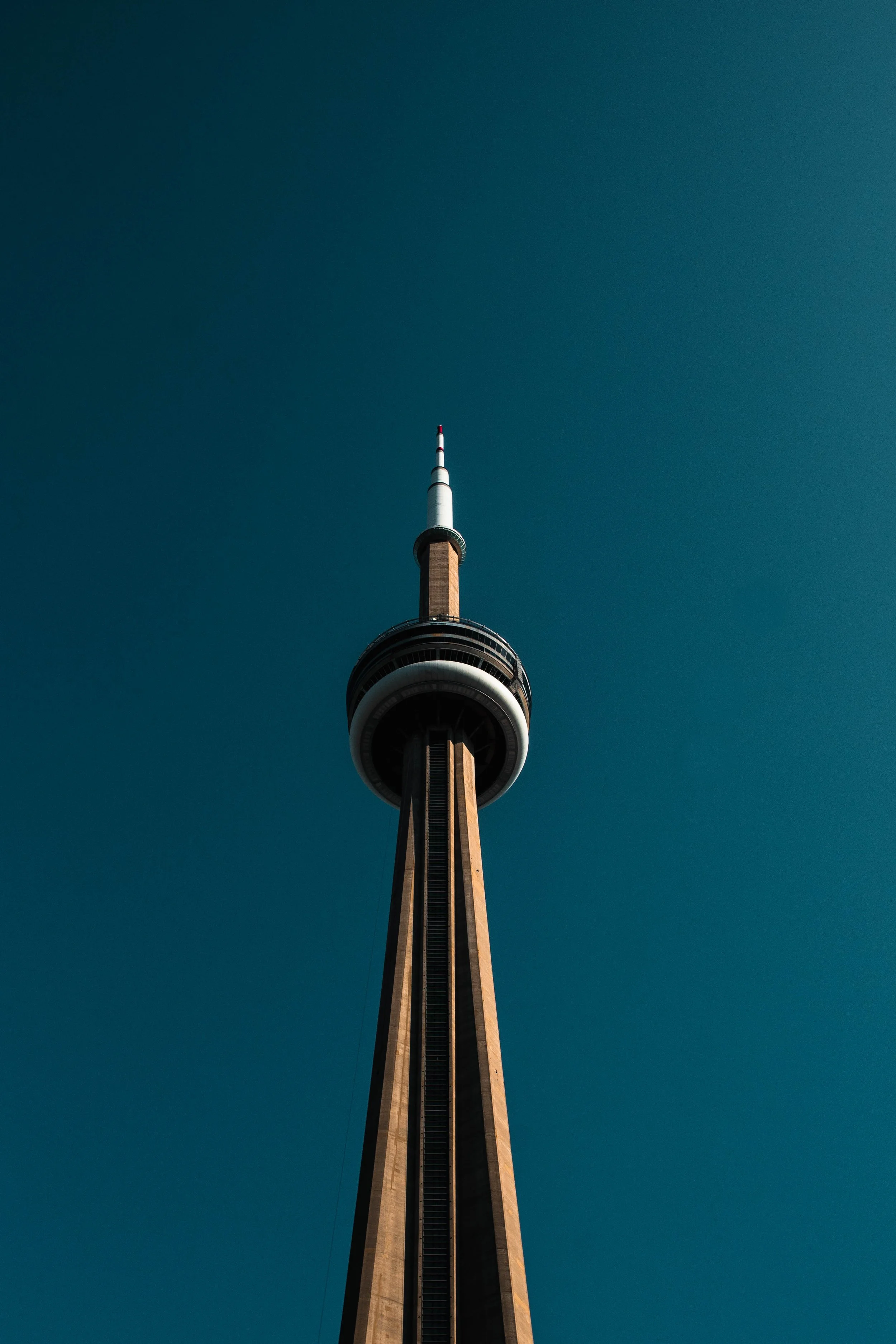 Toronto CN Tower against a clear blue sky.