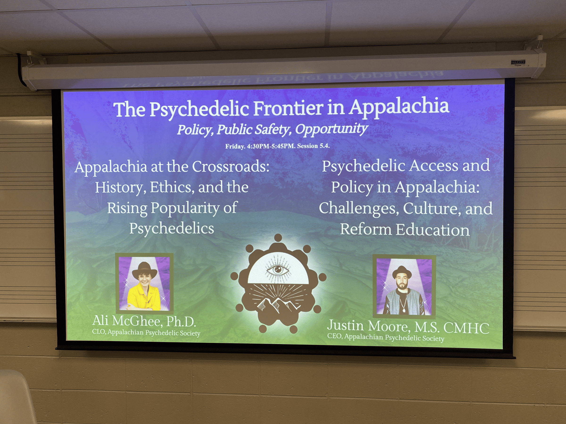 A slide image displayed on a projector with information about a talk being given