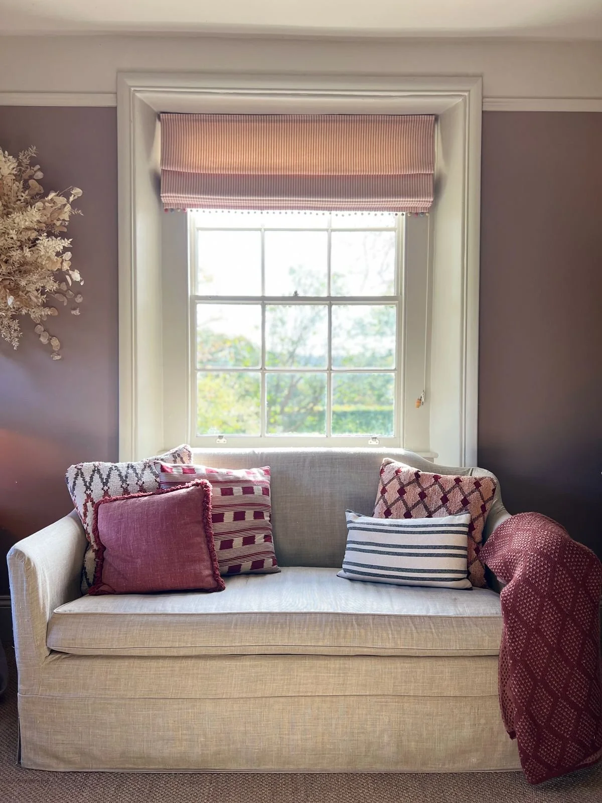 Cotswold country home interior design featuring layered neutral furnishings, natural materials and heritage architectural detailing