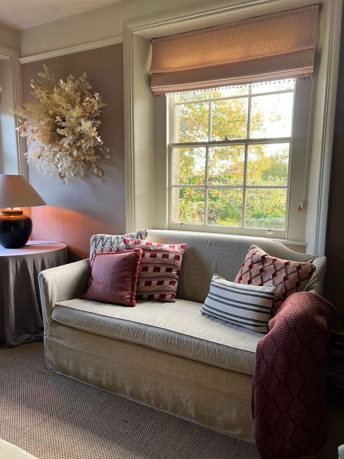 Interior design for a Cotswold country house with warm timber floors, soft linen upholstery and a relaxed rural aesthetic