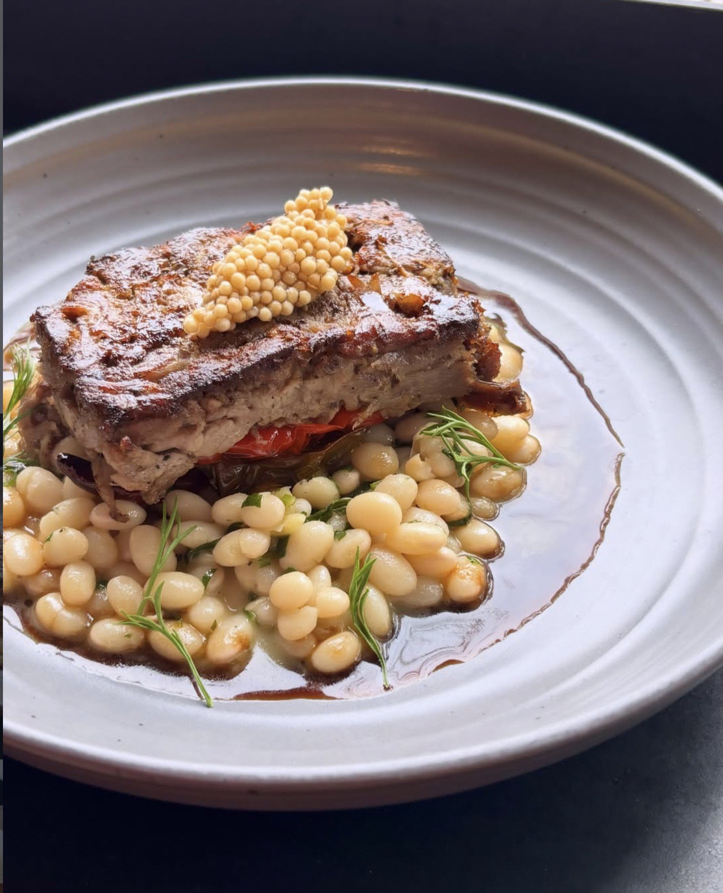 We're feeling the autumn vibes with this Wood Fired Lamb Shoulder at Prairie Fire in Brookline: Alubia Blanca beans, Jimmy Nardello peppers, pickled mustard seed, lamb jus