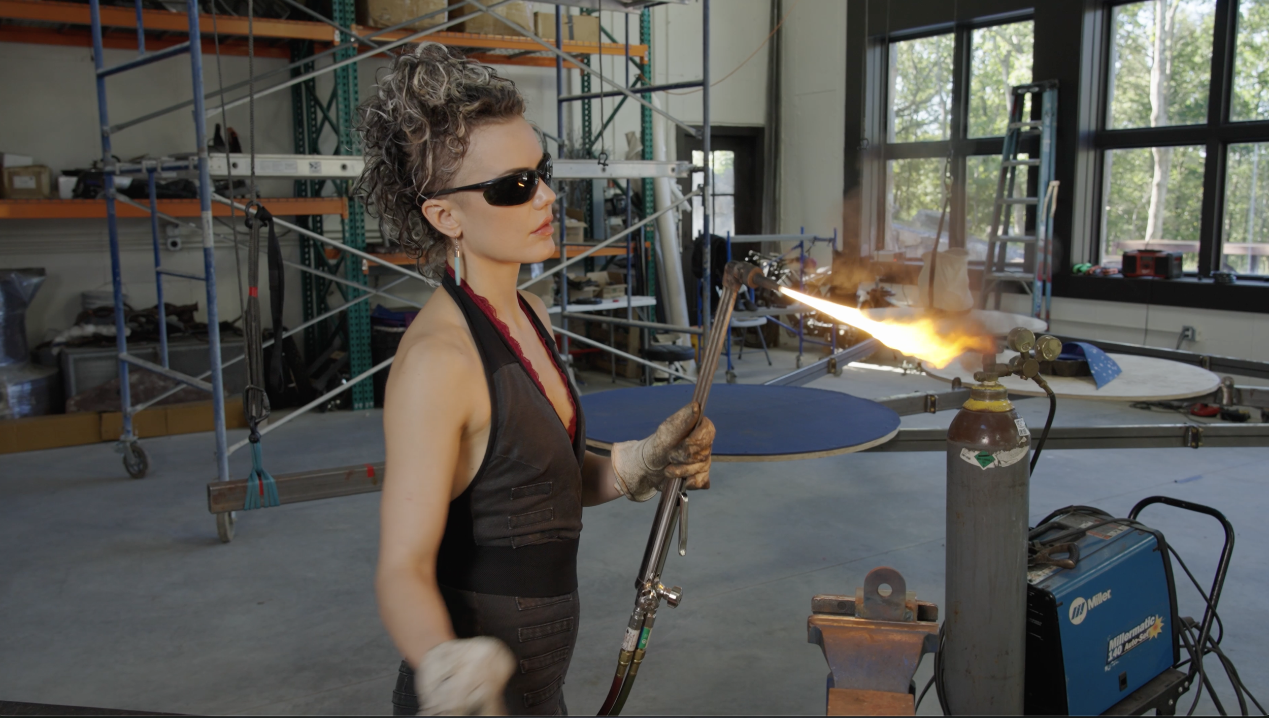 Artist-in-residence working with a blowtorch on a metal sculpture inside the 20 Manor studio, Westchester County, Upstate New York, near New York City