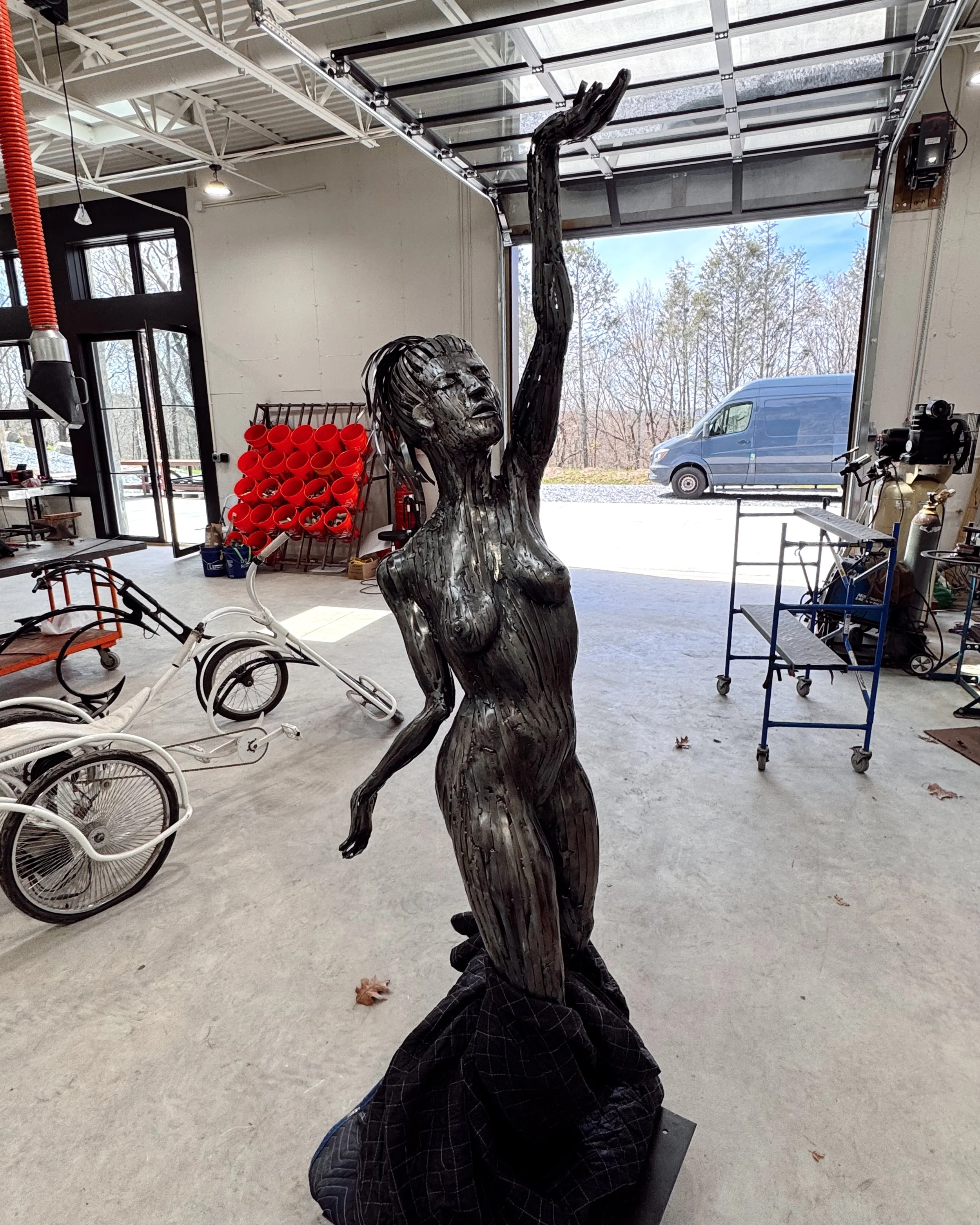 Metal sculptor working in the art studio at 20 Manor, an artist residency in Westchester County, Upstate New York, near New York City