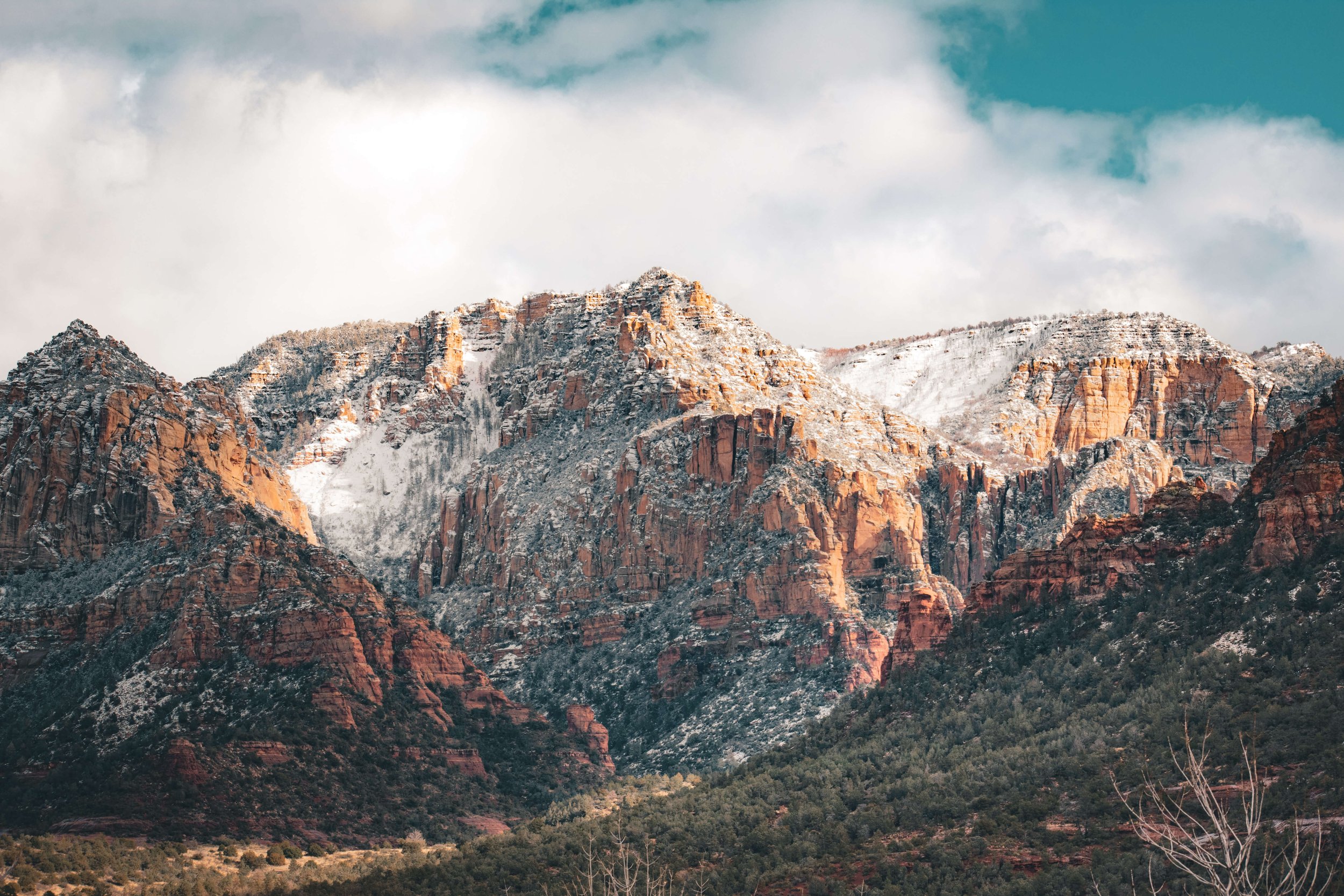 Red Rocks of Sedona, Arizona, at sunset, lightly covered in snow, high desert, Northern Arizona, USA, clouds, blue sky, hiking, American Southwest.