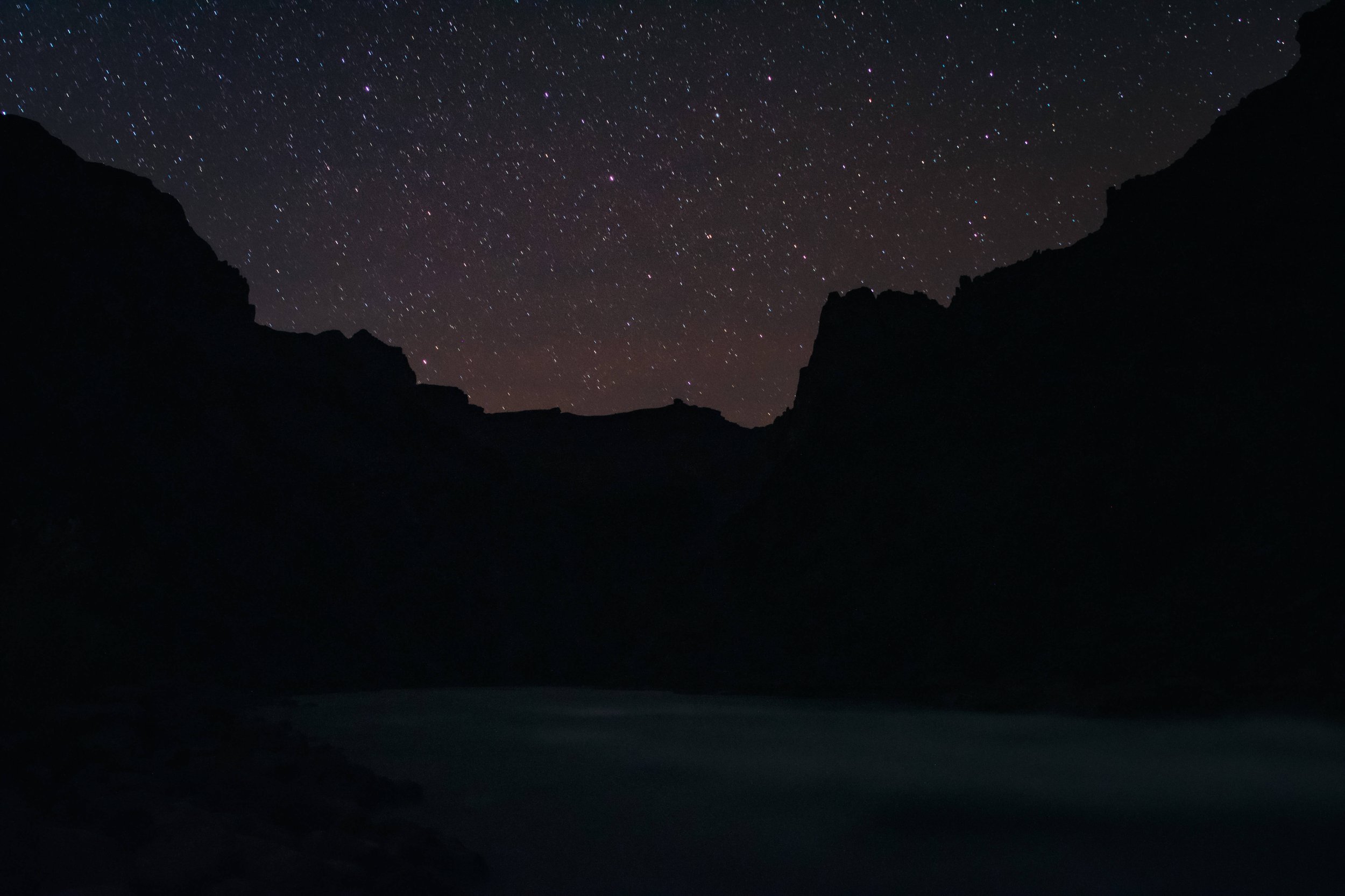 View of a starry night, dark skies rising from a camp site on the shores of Hermit Rapids on the Colorado River, Grand Canyon National Park, Arizona, USA, south rim, astrophotography, river, backpacking, hiking, tent, starry night, desert, natural wo