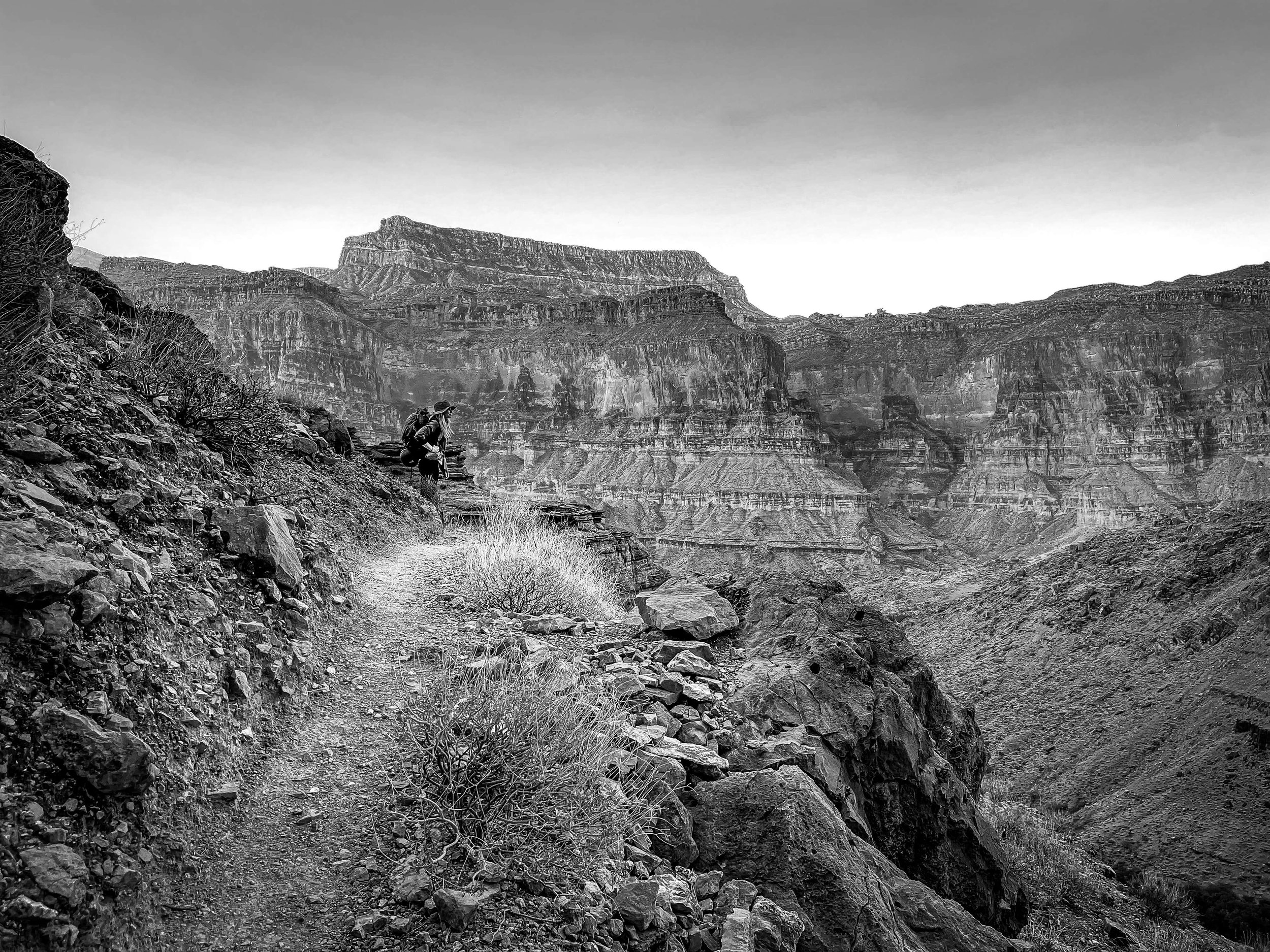 Black and white canyon photo of a lone female backpacker on the Bill Hall, Thunder River, Deer Creek Falls Trail, Grand Canyon, Arizona, USA, north rim, backpacking, Grand Canyon National Park, Colorado River, desert, wonders of the world, hiking, ca