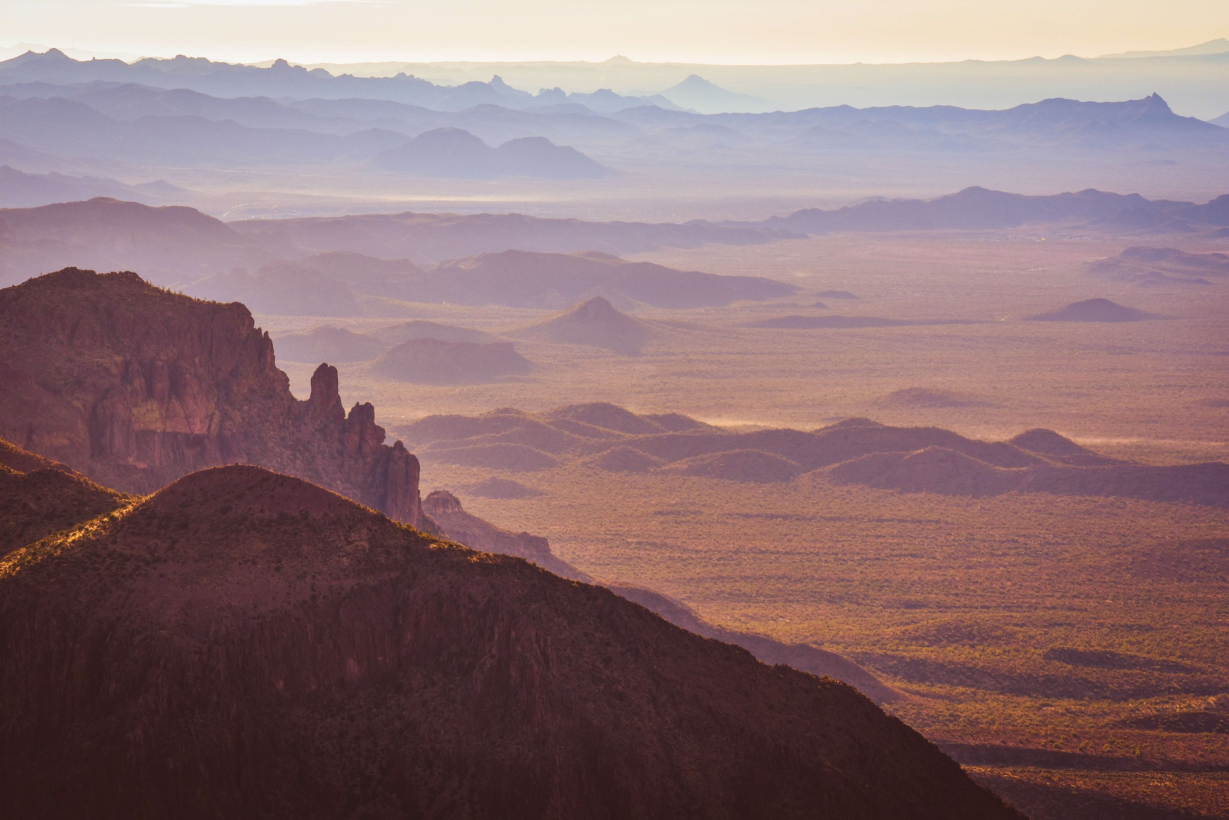 Sunrise over the desert landscape of the Superstition mountains, layers, Gold Canyon, Apache Junction, Arizona, USA, desert, desertscape, hiking, Flat Iron hiking trail, summit, cliff edge, American Southwest.