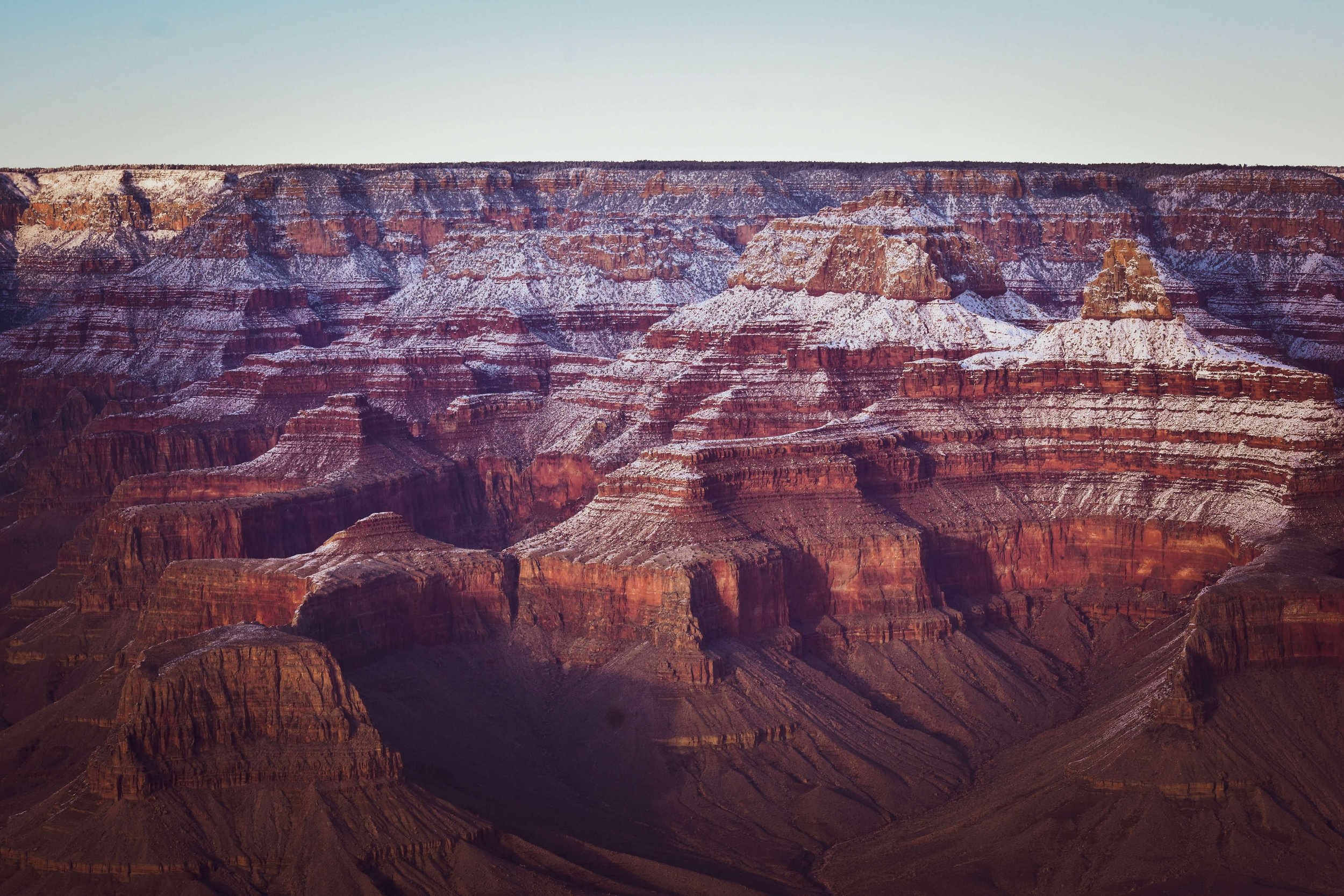 Sunset golden hour, south rim overlook, lookout, light dusting of snow at the Grand Canyon National Park, Arizona, USA, sun rays, snow, natural wonders of the world, camping, cliff edge, northern Arizona, Colorado River, American Southwest.