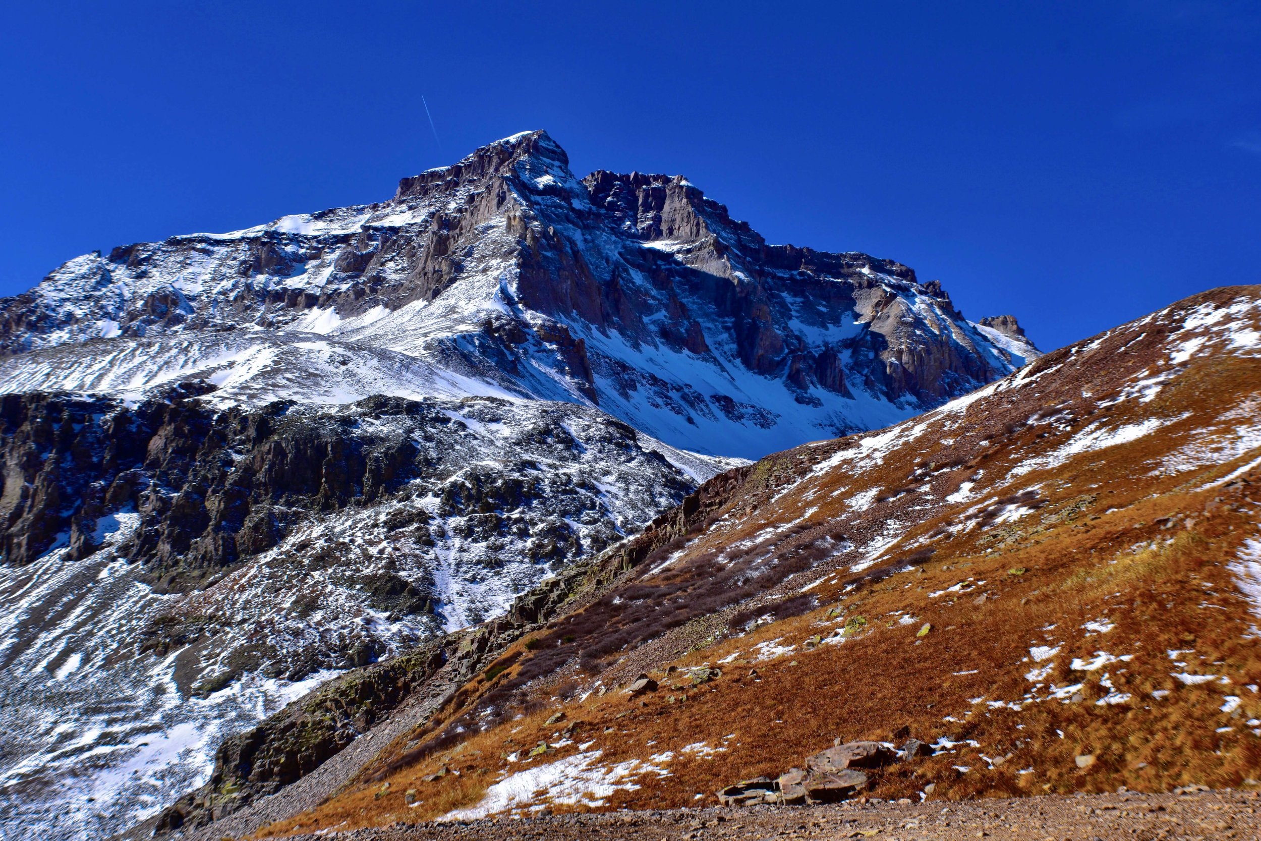 Jagged mountain peaks rising in Colorado, USA, snow and rock, cliff faces, blue sky, cliff edge, rock climbing, hiking, intimidating mountains, 14ers, 14,000 feet peak, Mount Sneffels, wilderness, Ouray Colorado, USA, Telluride, Rocky Mountains, Rock