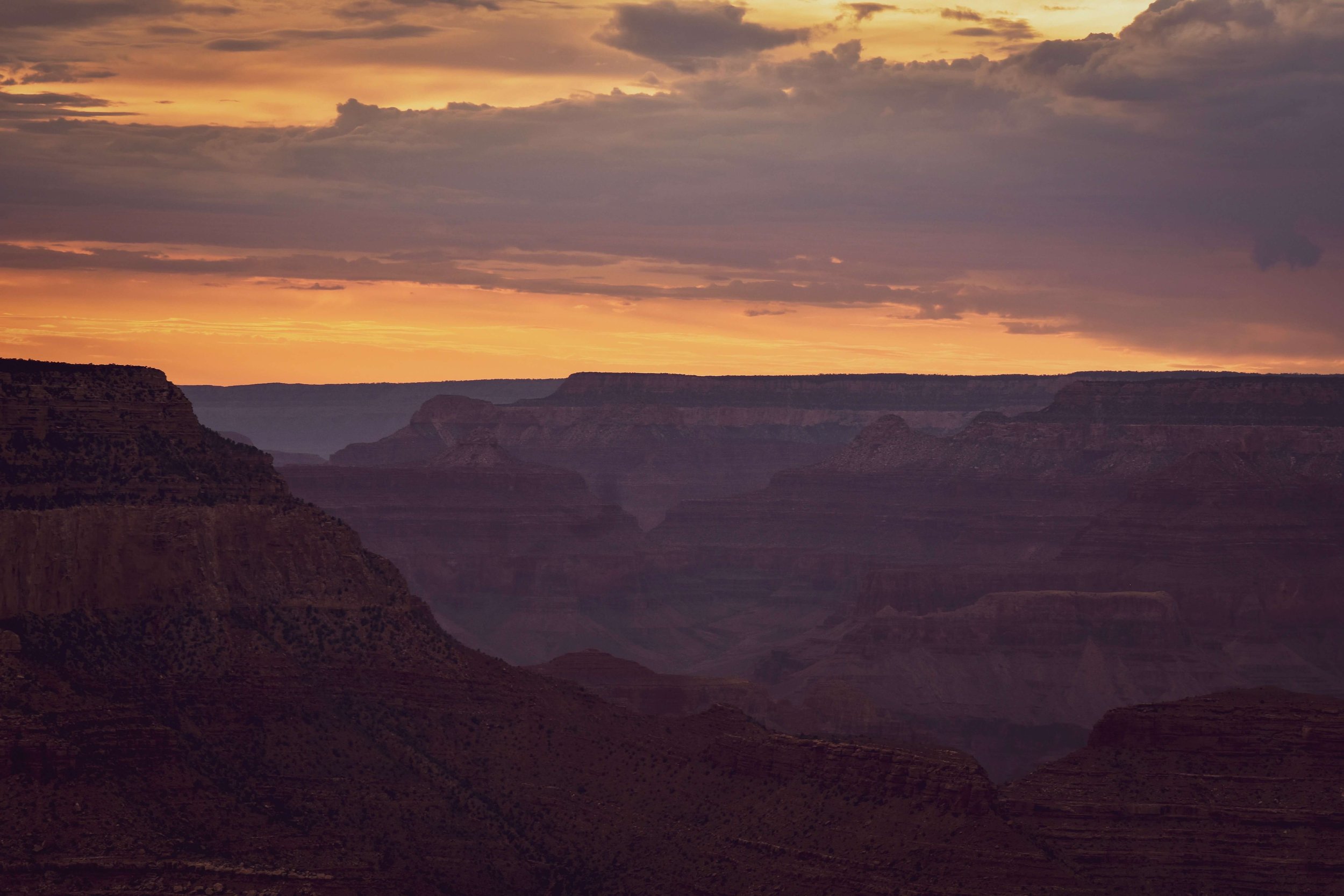 Sunset twilight, golden hour, south rim overlook, lookout, at the Grand Canyon National Park, Arizona, USA, sun rays, natural wonders of the world, camping, cliff edge, northern Arizona, Colorado River, American Southwest, monsoon, rain, storm clouds