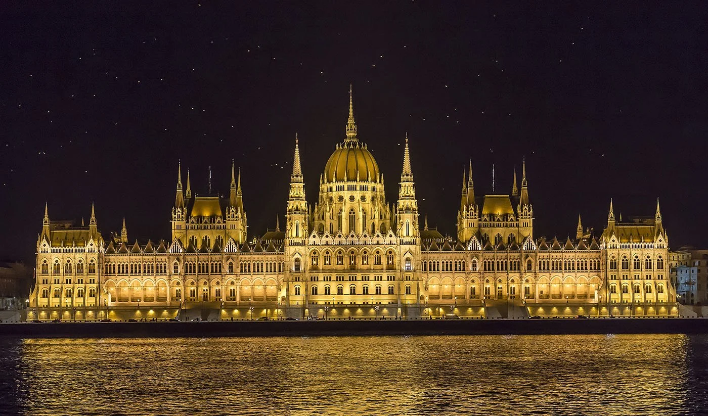 Birds Flock Over Budapest Parliament at Night