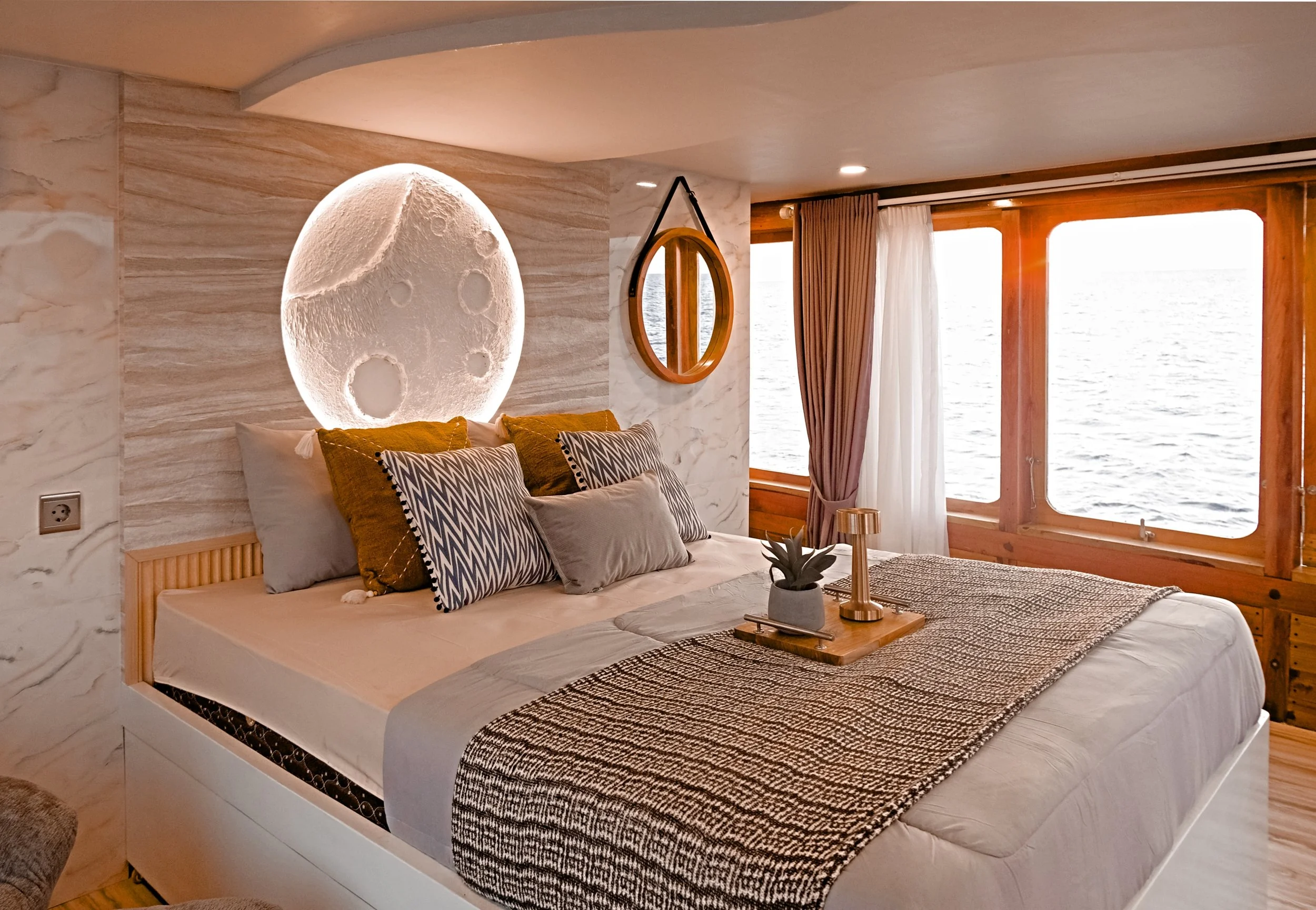 “Boutique marine interior reset in Stuart, Florida at Harborage Yacht Club featuring luxury yacht cabin with organized bedding and detailed finishes.”