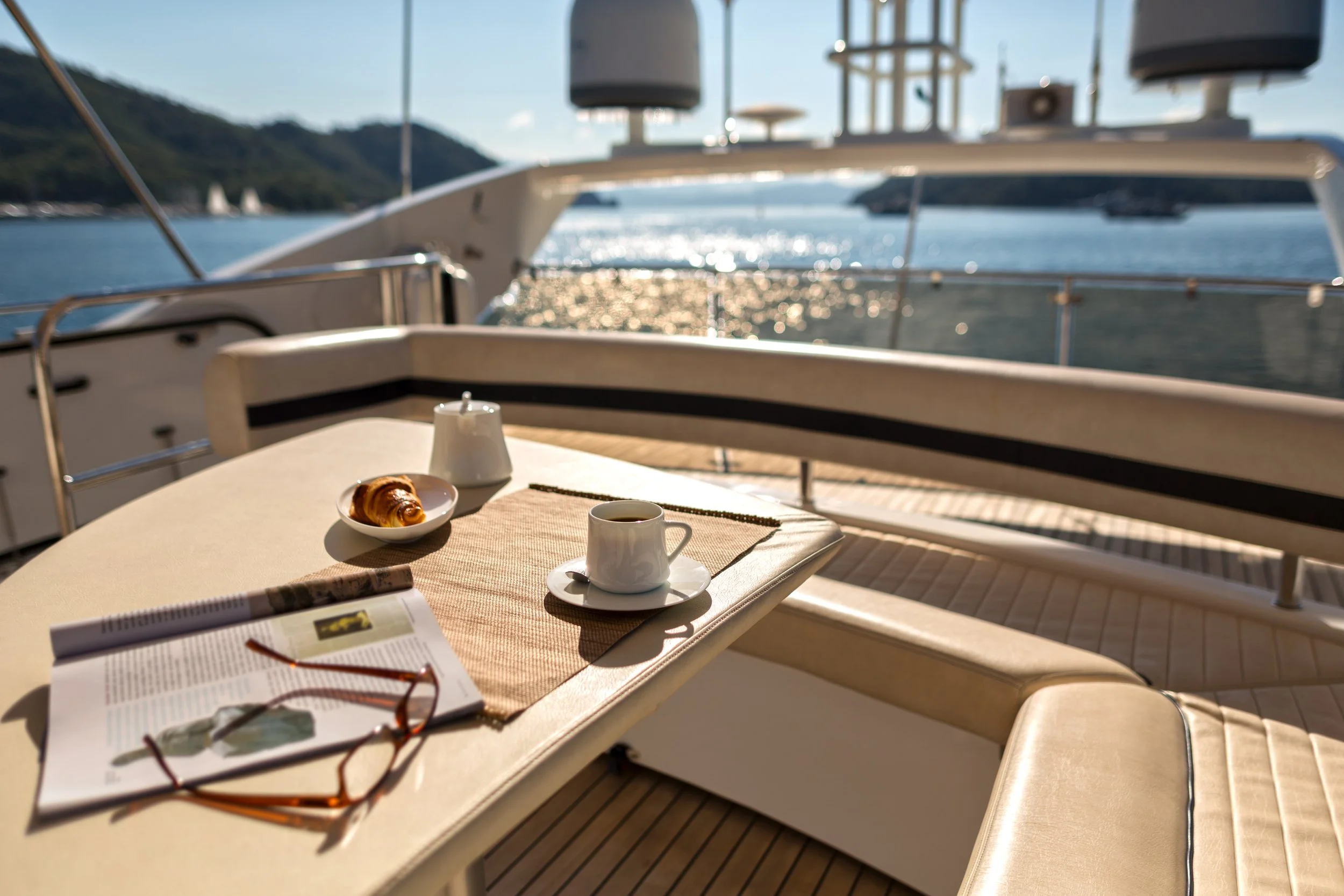 “Luxury yacht deck prepared for owner arrival in Stuart Florida featuring organized seating and morning coffee setting.”