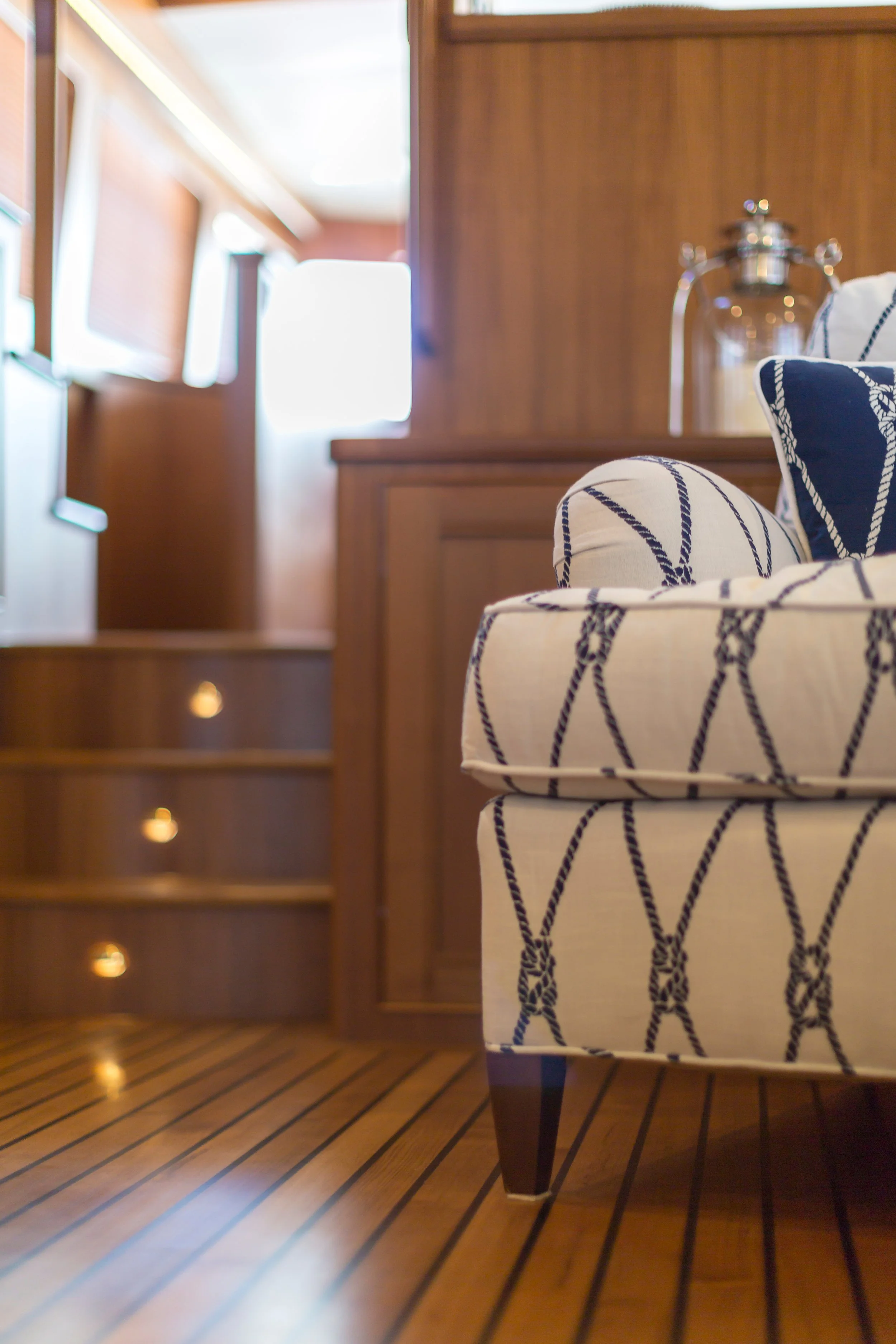 "Refined yacht interior seating area with teak flooring representing Chaos Untangled® marine interior detailing and organizing services in Stuart, Florida."