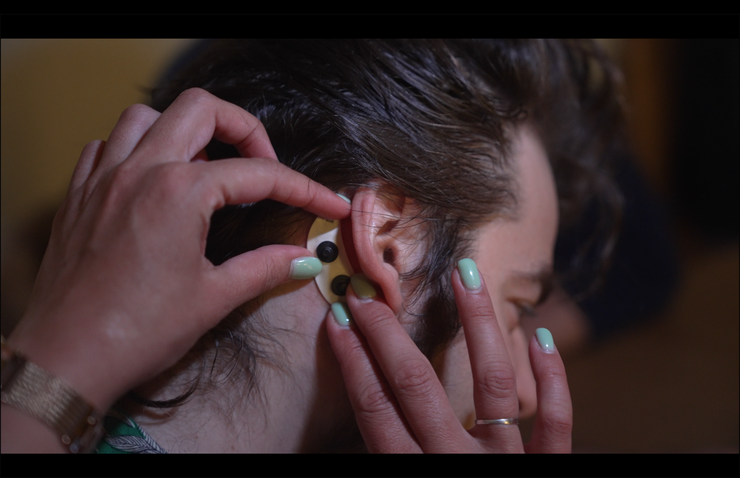 Device on Tim's ear.png