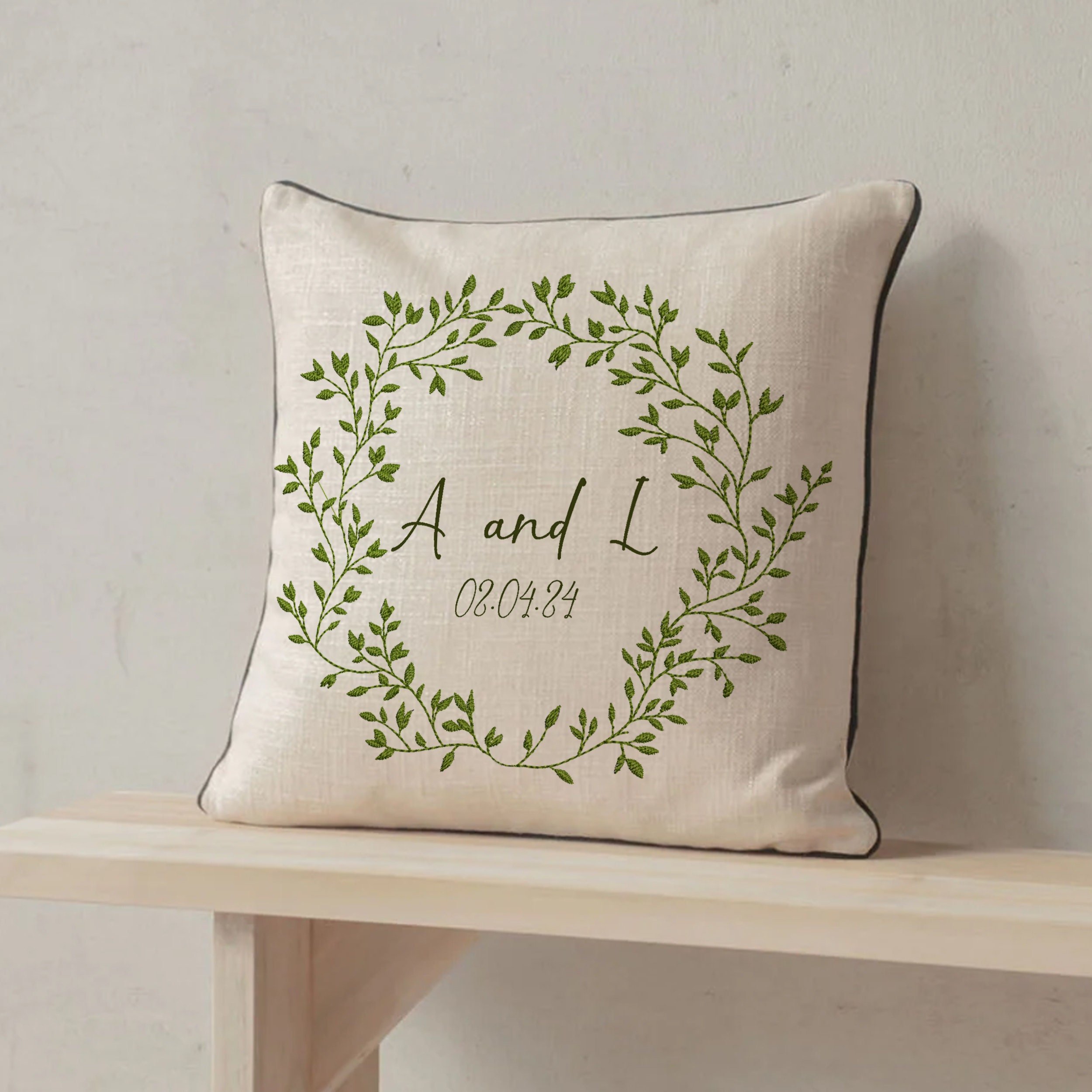 Rich Greenery Wreath and Border Machine Embroidery Design embroidered on a pillow