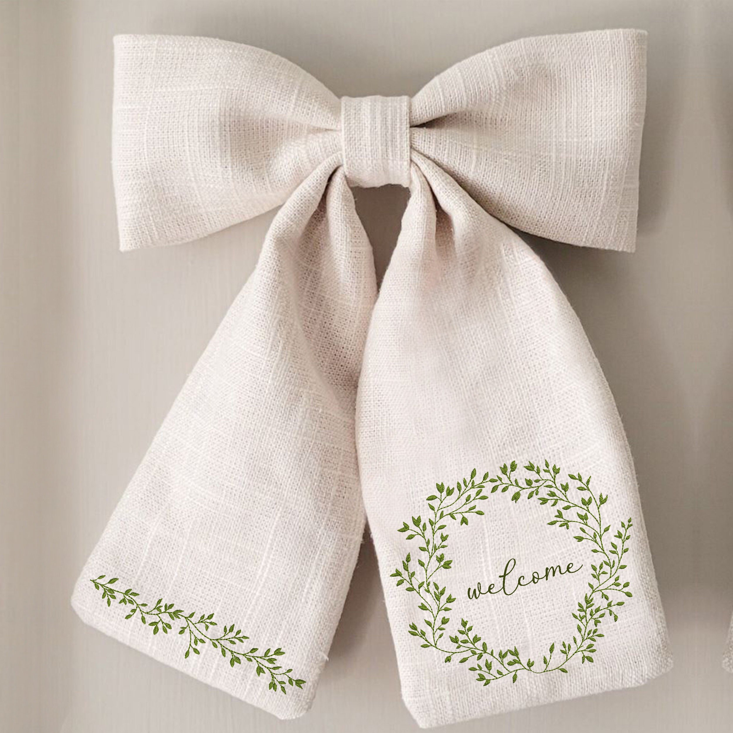Rich Greenery Wreath and Border Machine Embroidery Design embroidered on a bow
