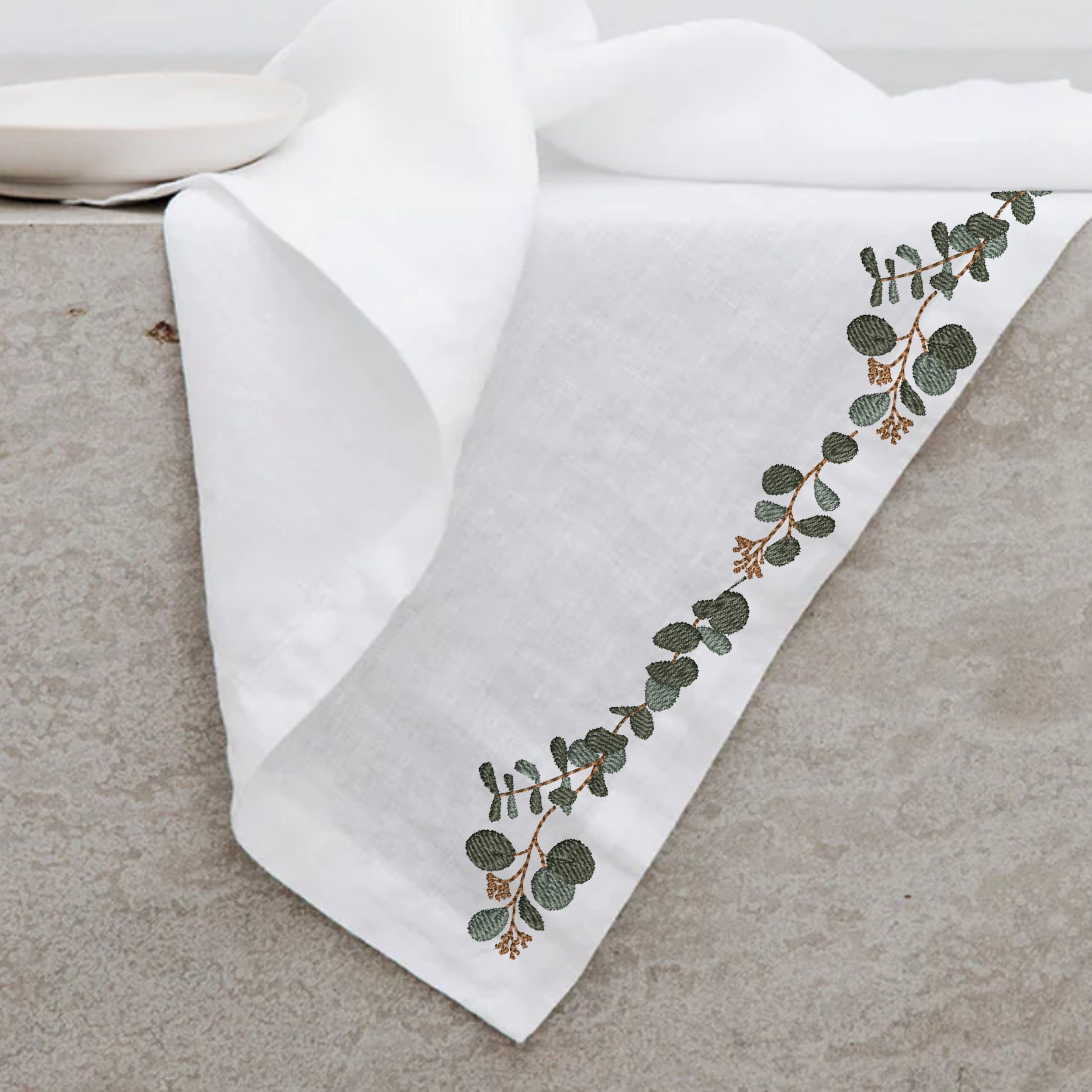 Modern Eucalyptus Wreath and Border Machine Embroidery Design Bundle embroidered on a table cloth