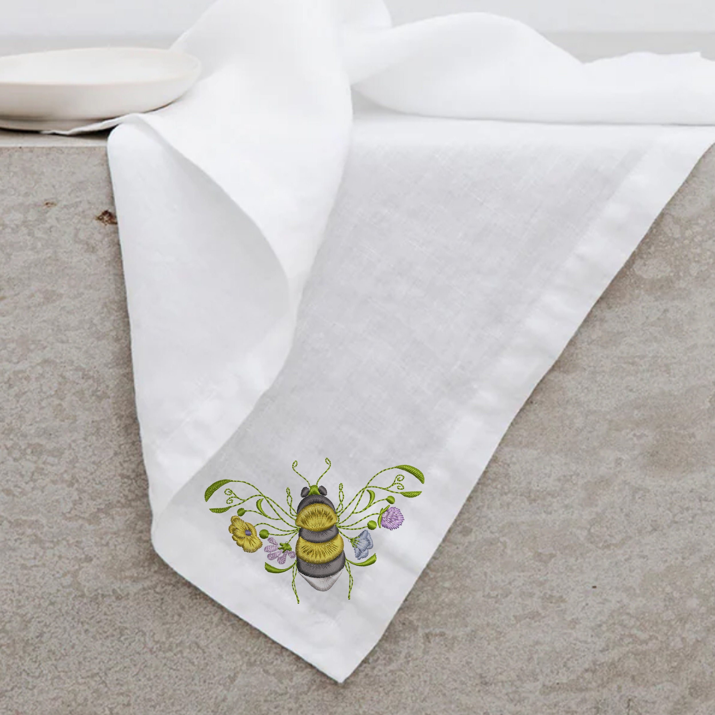 Garden Flower Bee Machine Embroidery Design embroidered on a linen napkin