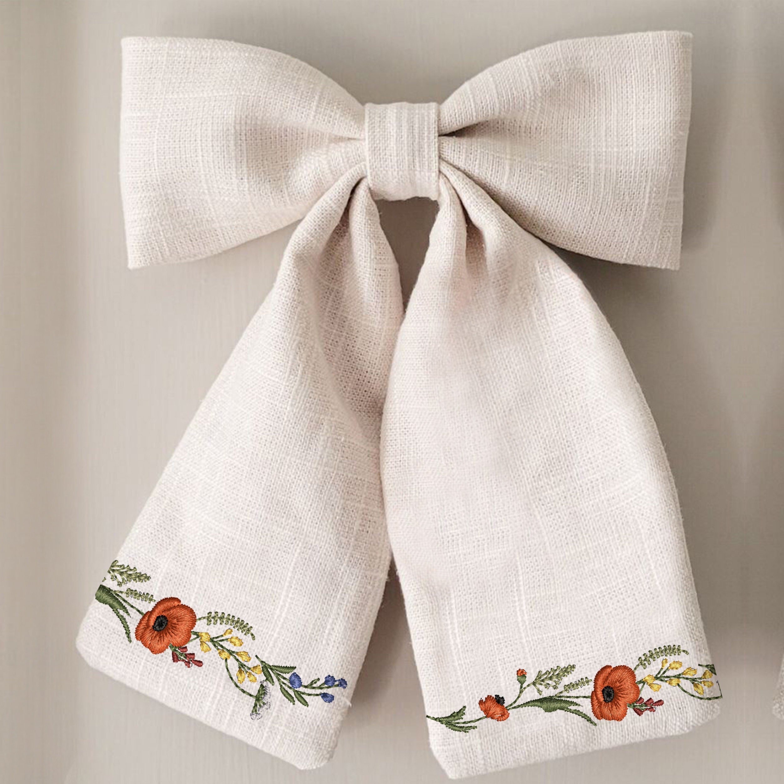 Cowgirl Poppy Wildflower Meadow Wreath and Border Machine Embroidery Design embroidered on a bow