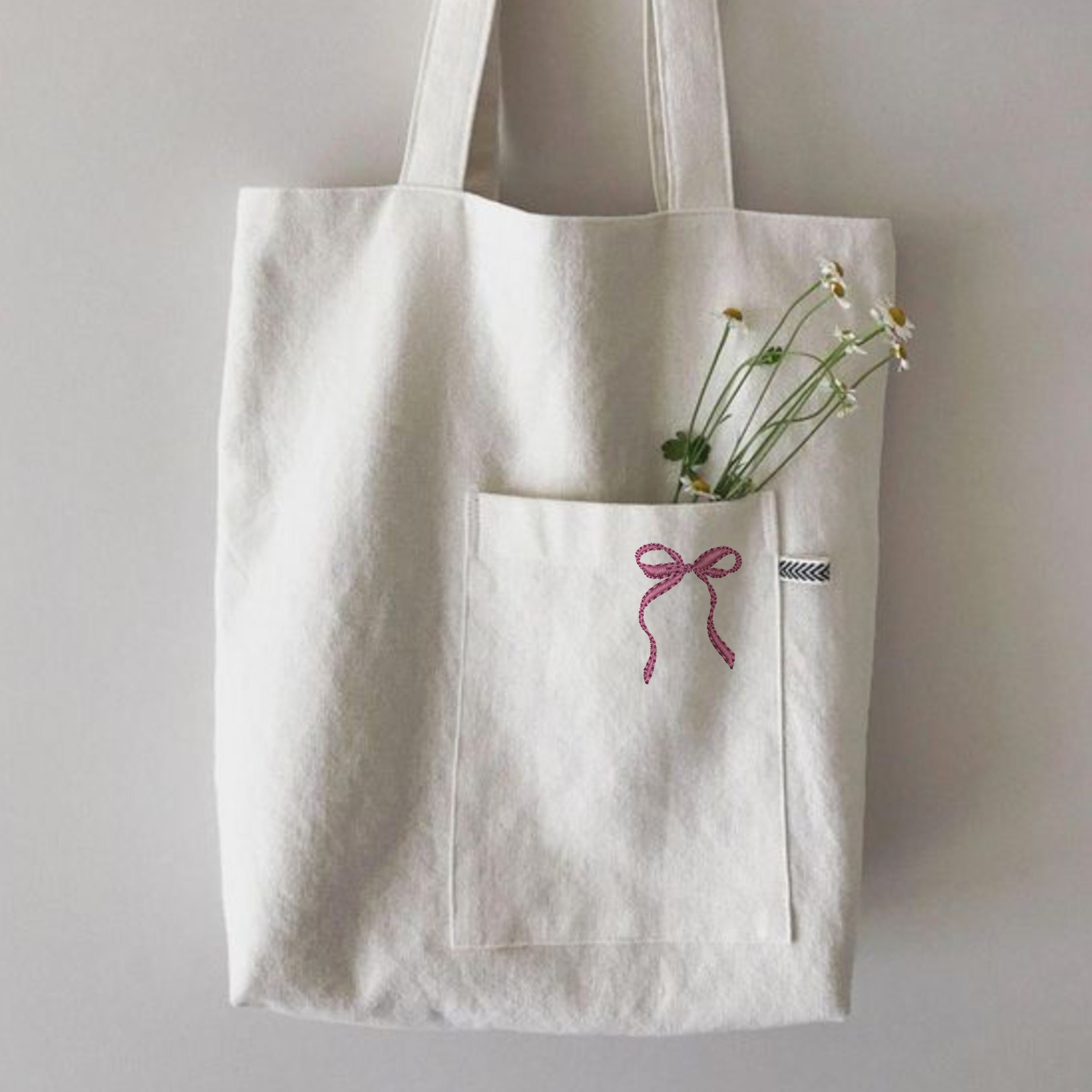 Amazing Bow Collection Machine Embroidery Design embroidered on a handbag