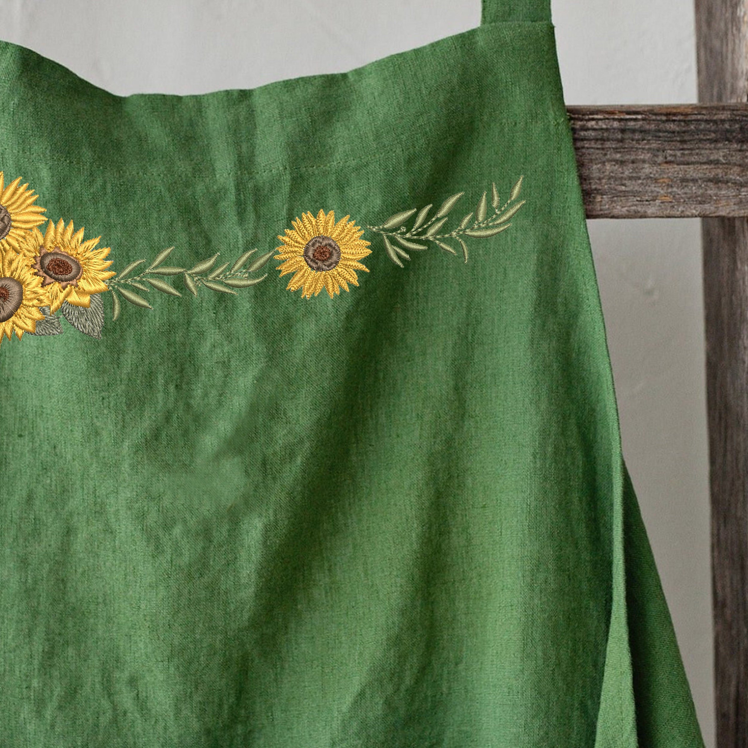 Sunflower Border and Bouquet Machine Embroidery Design File Bundle embroidered on a linen apron