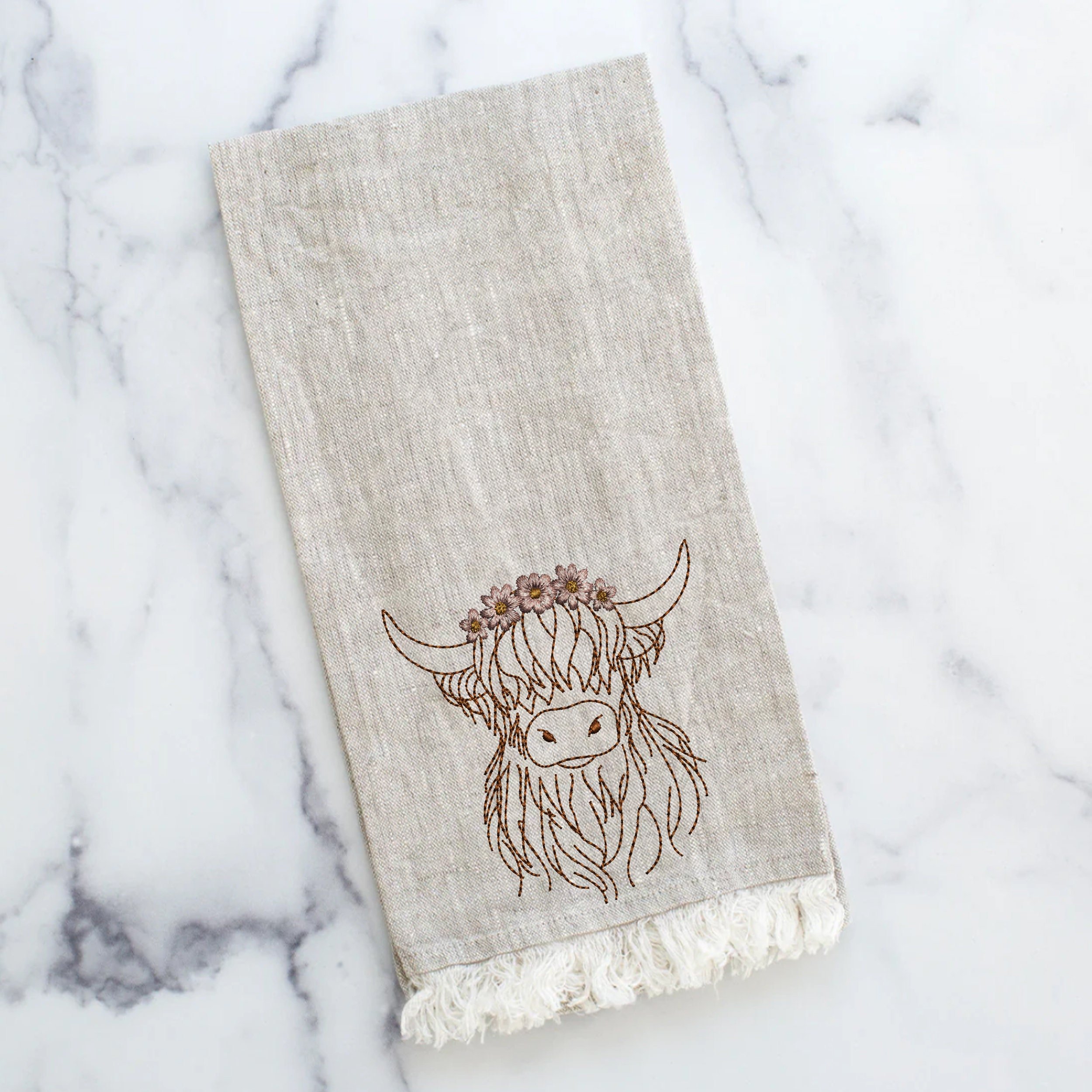Highland Scottish Cow Machine Embroidery Design File embroidered on a linen kitchen towel