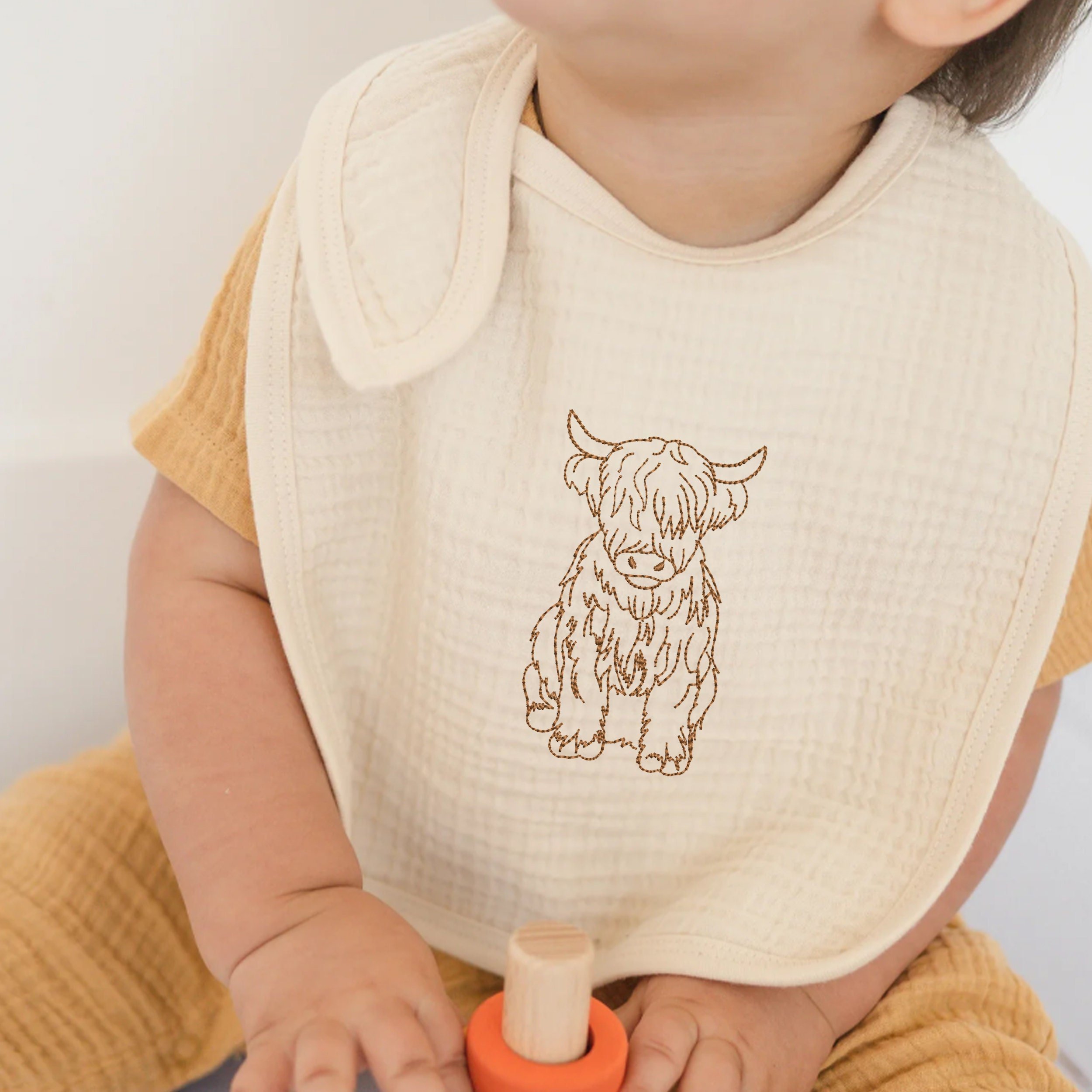 Highland Scottish Cow in Wildflower Garden Machine Embroidery Design File embroidered on toddler's bib
