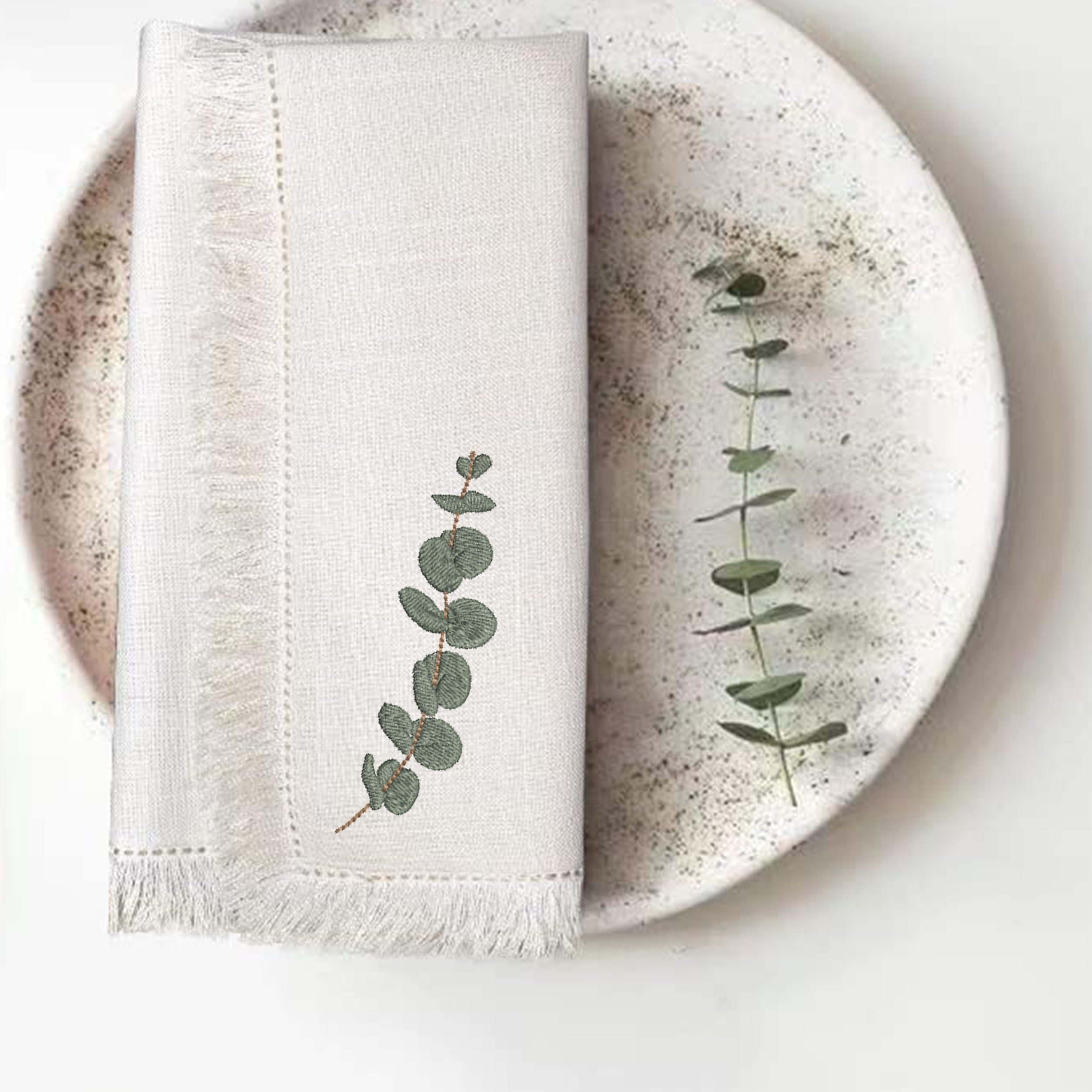 Eucalyptus Laurel Branch Machine Embroidery Design embroidered on a napkin