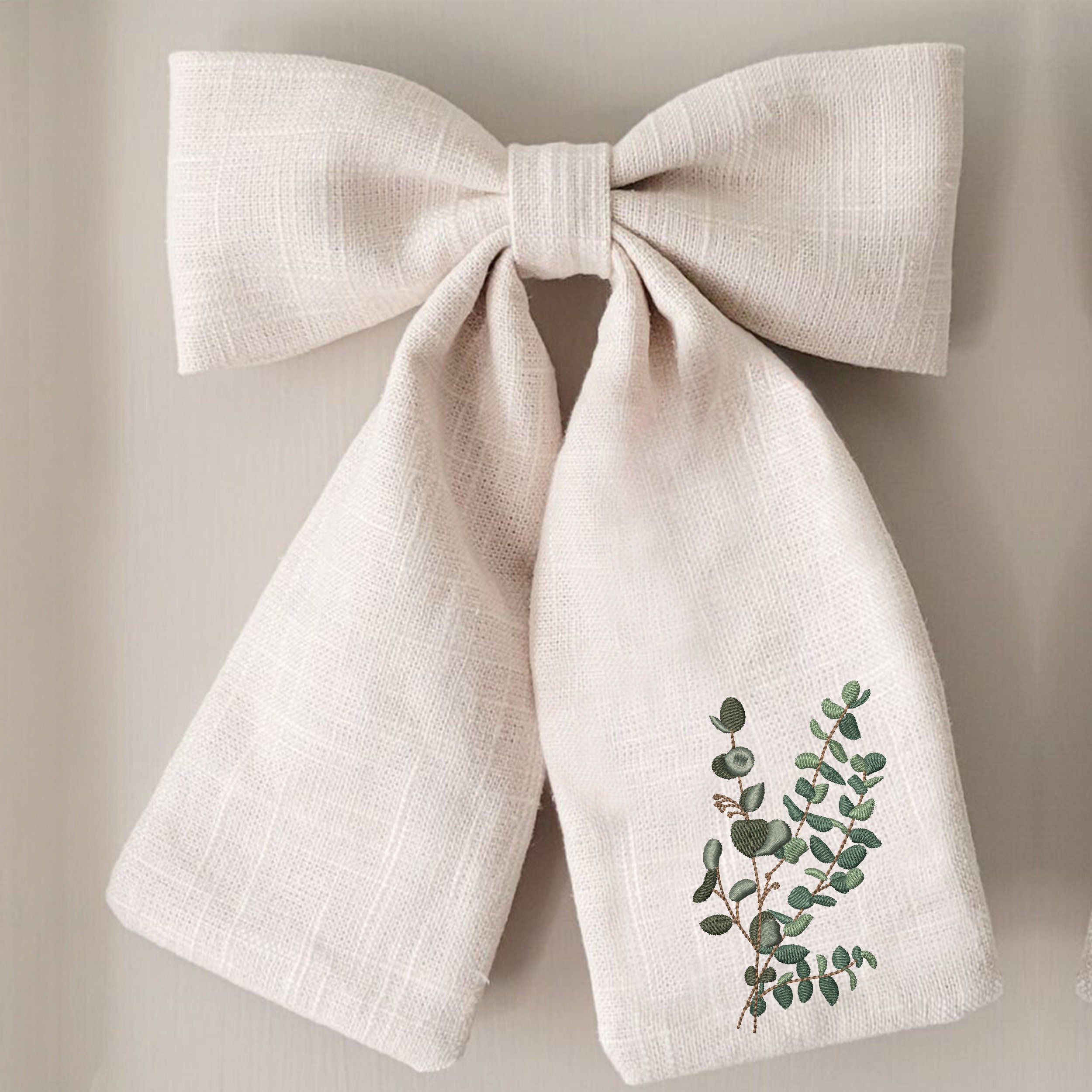 Eucalyptus Laurel Branch Machine Embroidery Design embroidered on a bow