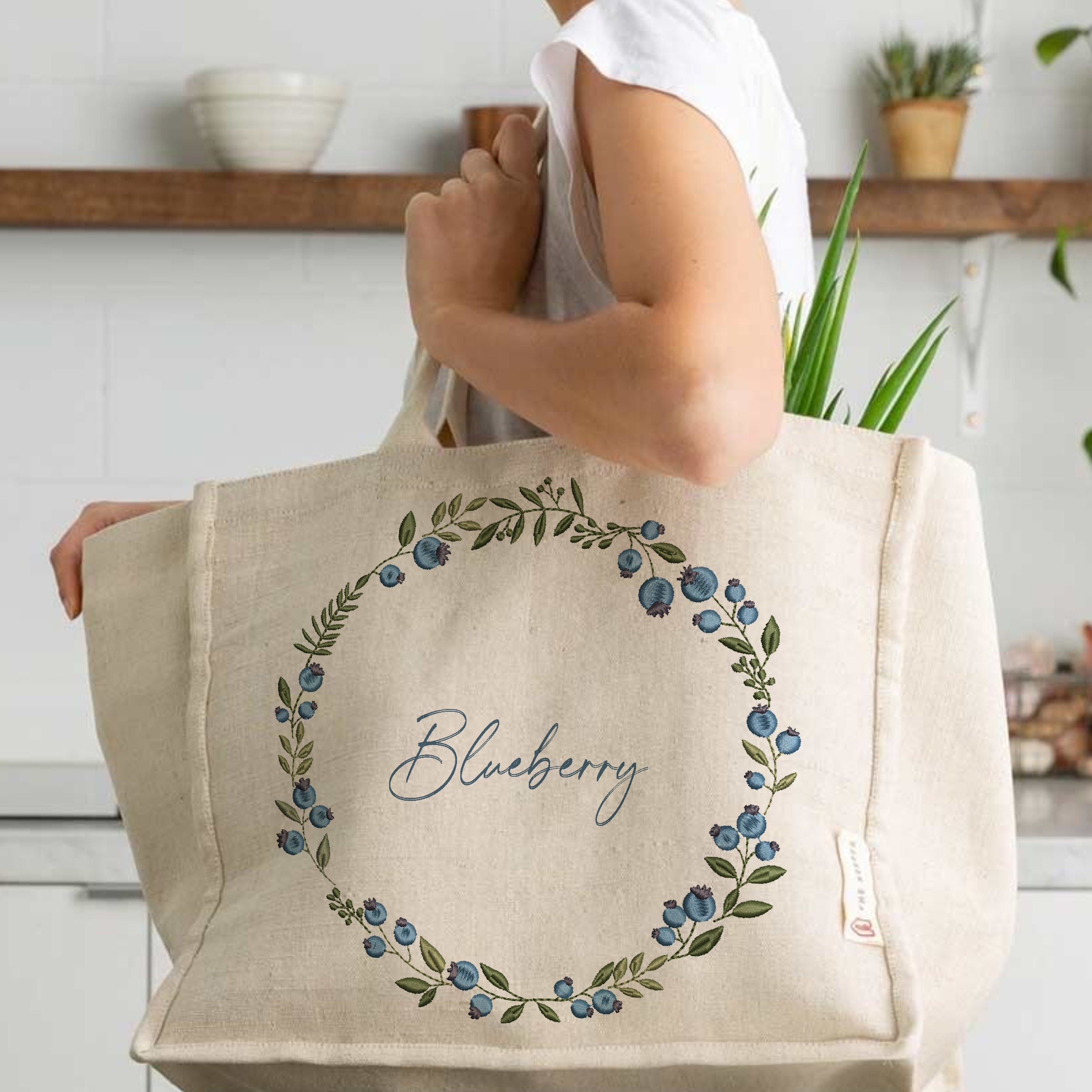 Blueberry Wreath and Border Machine Embroidery Design File embroidered on a handbag