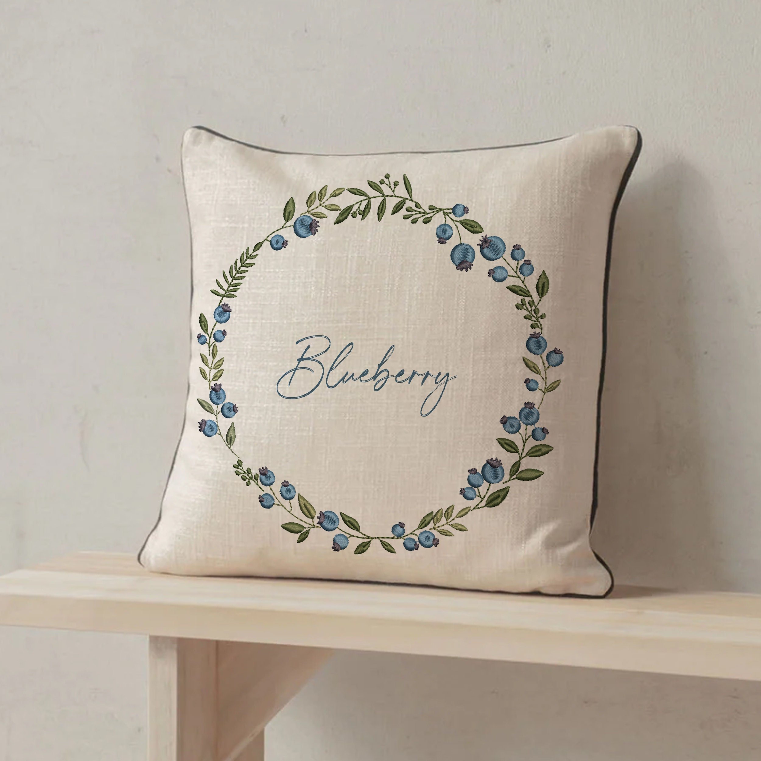 Blueberry Wreath and Border Machine Embroidery Design File embroidered on a pillow