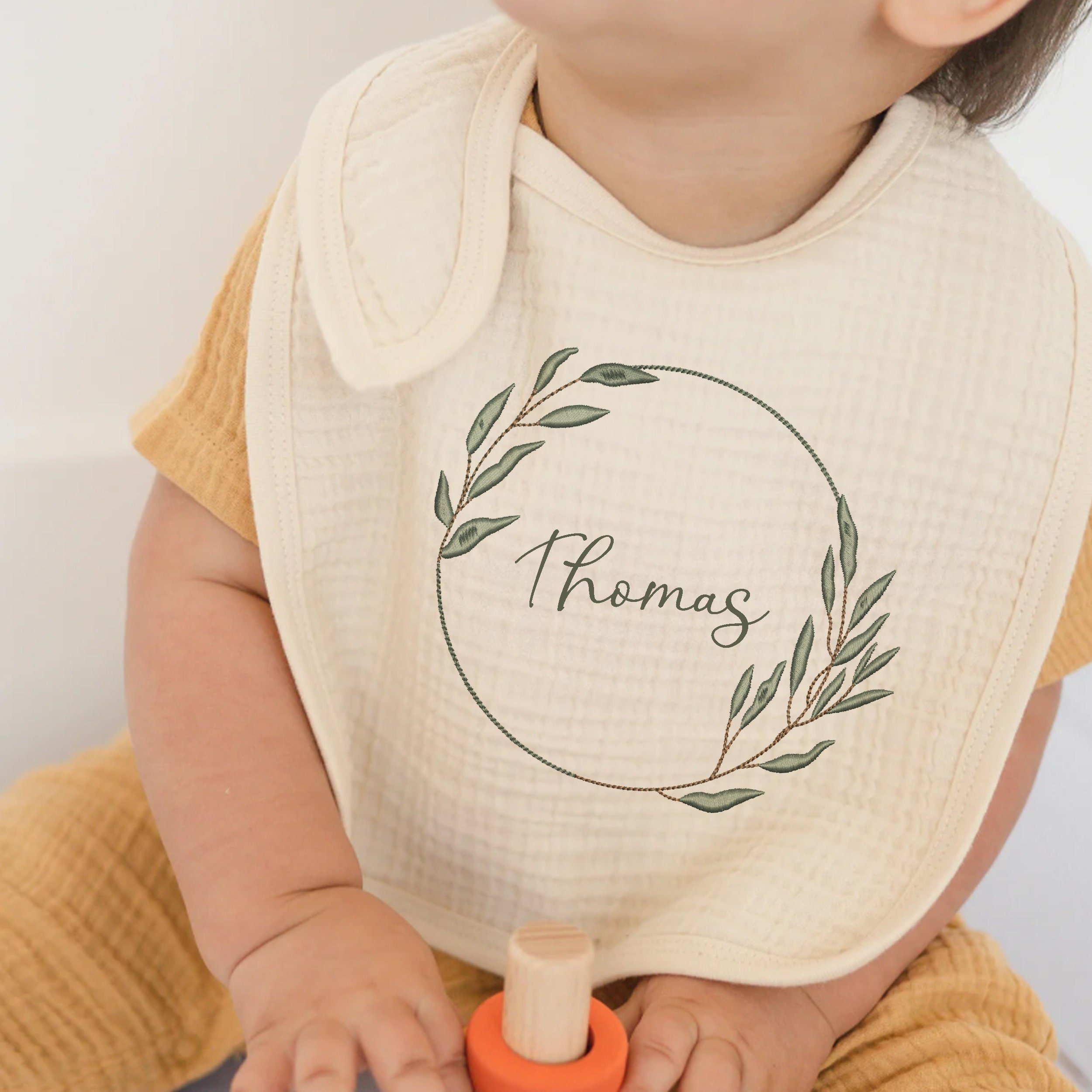 Eucalyptus Laurel Wreath and Branches Machine Embroidery Designs embroidered on a bib