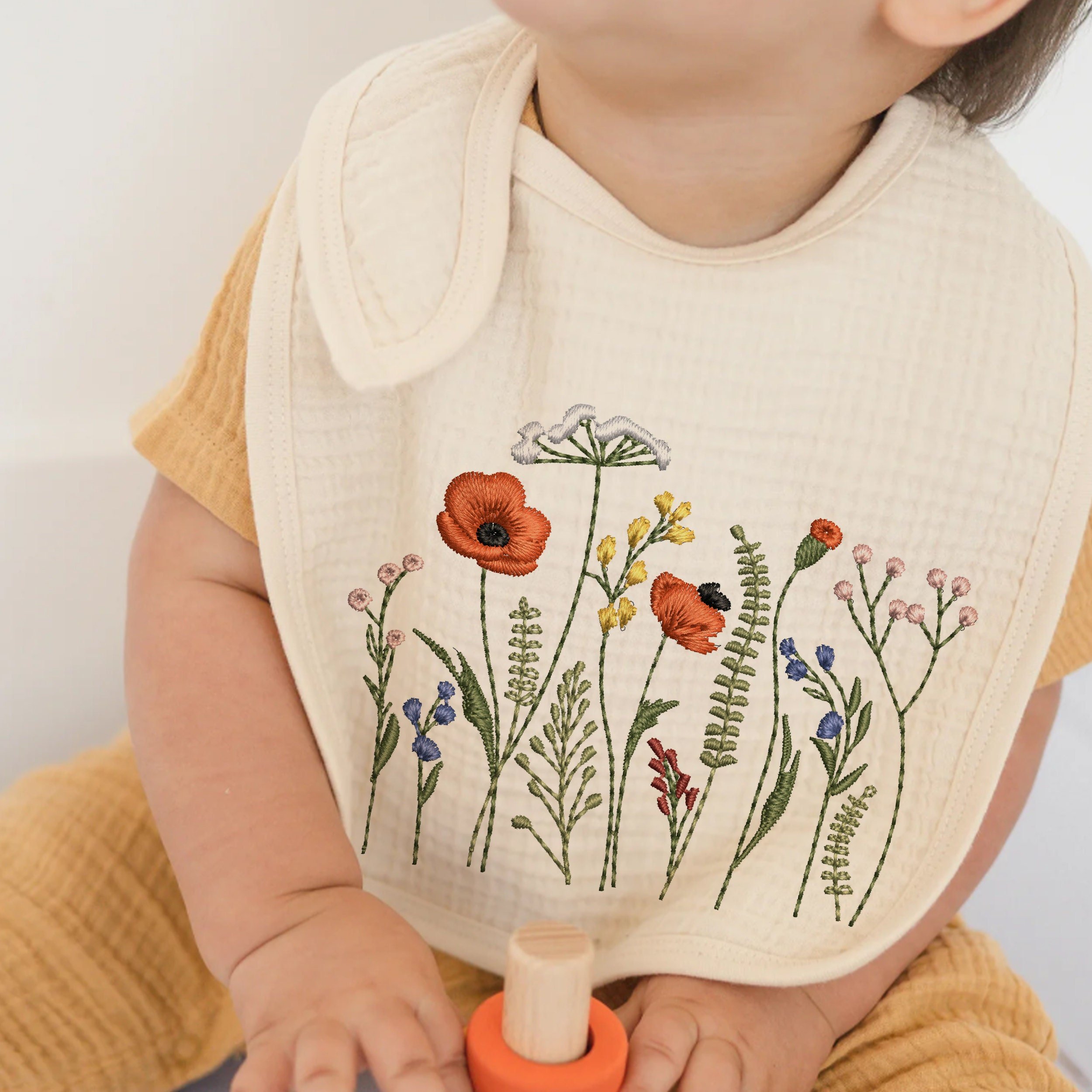 Cowgirl Wildflower Meadow Machine Embroidery Design embroidered on a bib