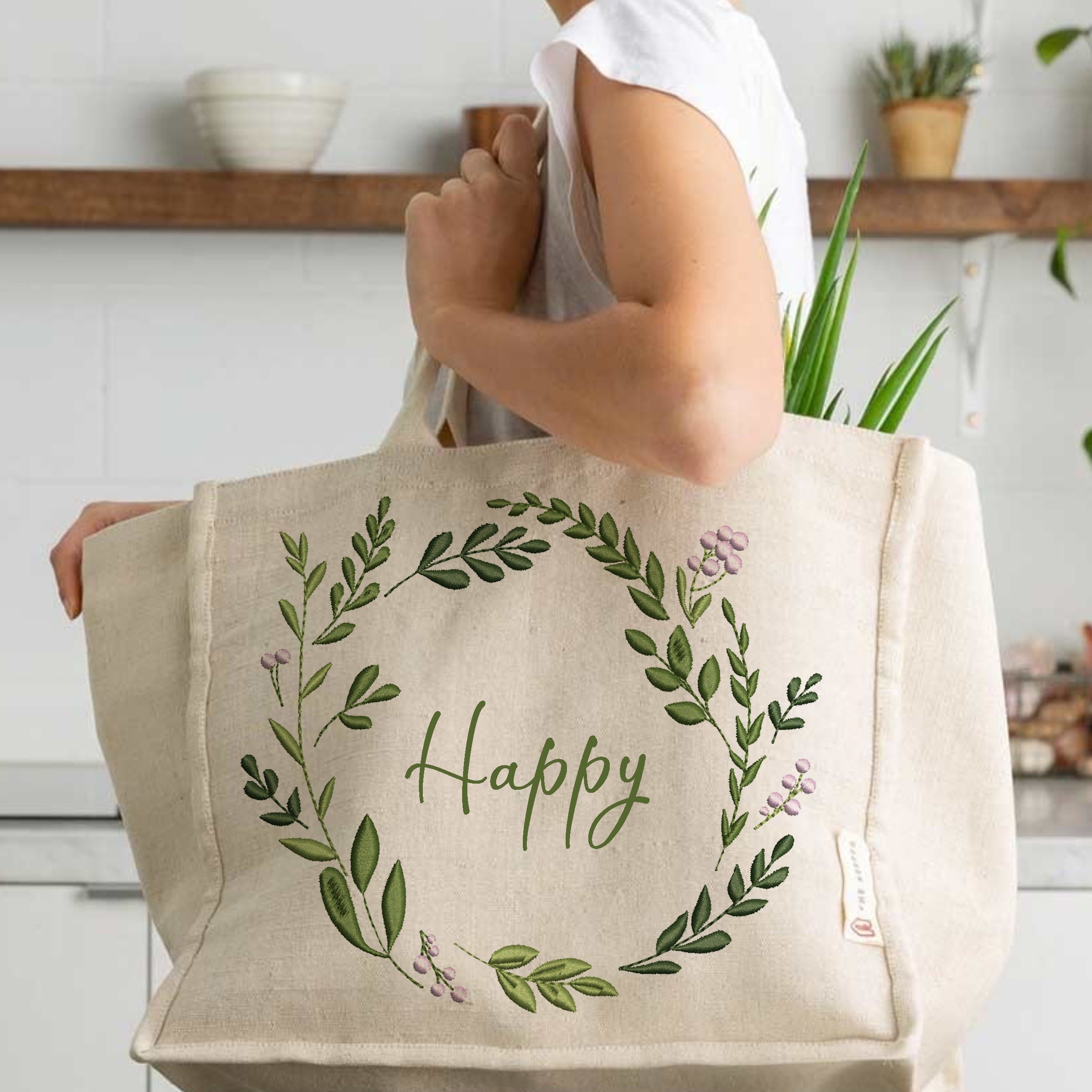 Happy Wreath and Border Machine Embroidery Design embroidered on a handbag