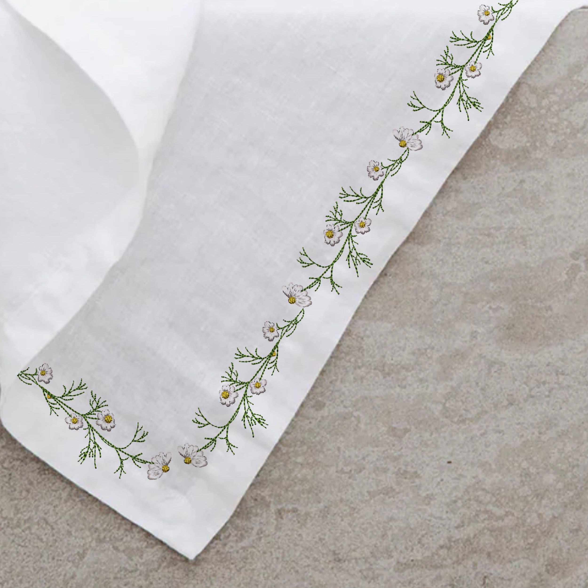 Chamomile Wreath and Border Machine Embroidery Design Bundle embroidered on a napkin