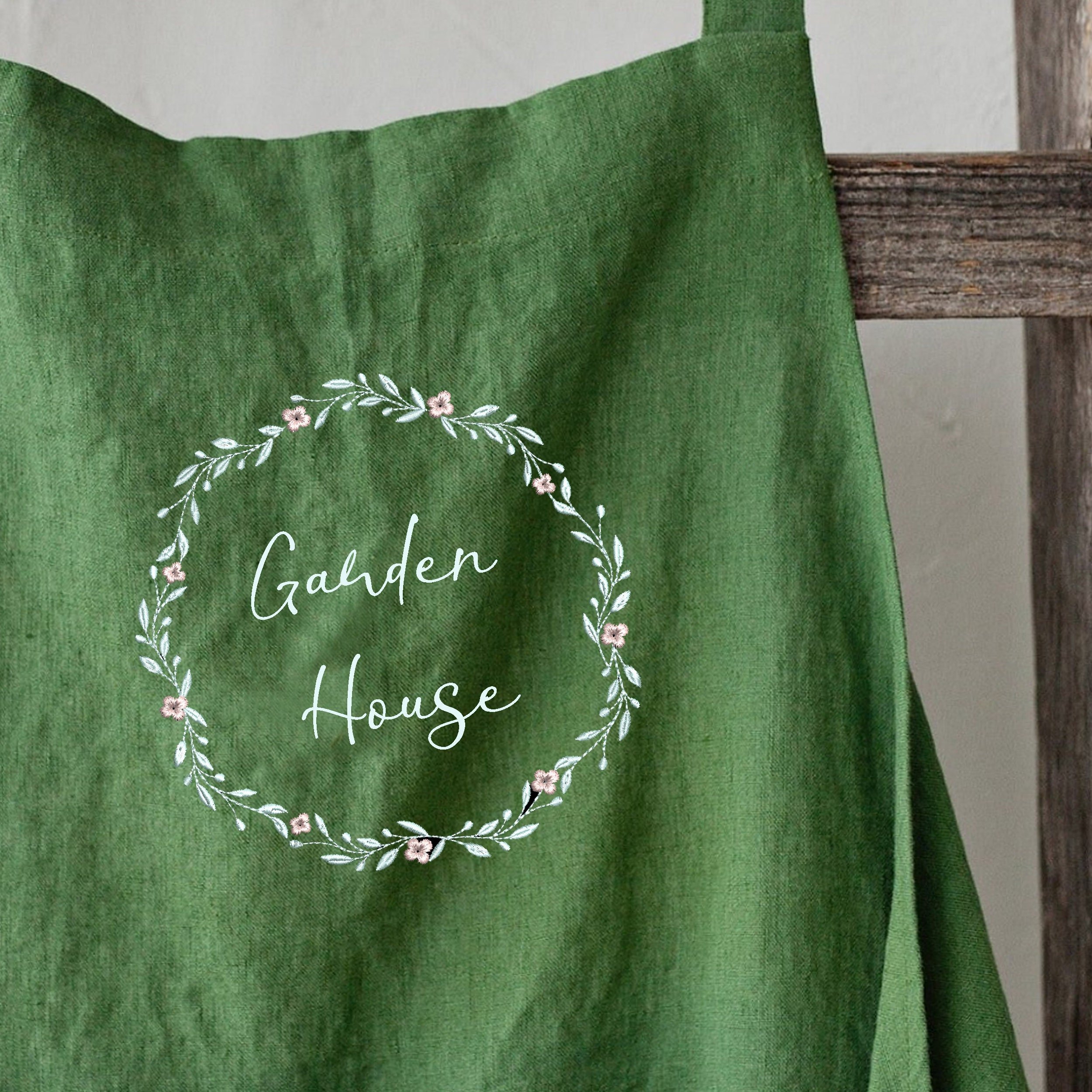 Favorite Floral Wreath and Border Machine Embroidery Design Pattern embroidered on a green apron