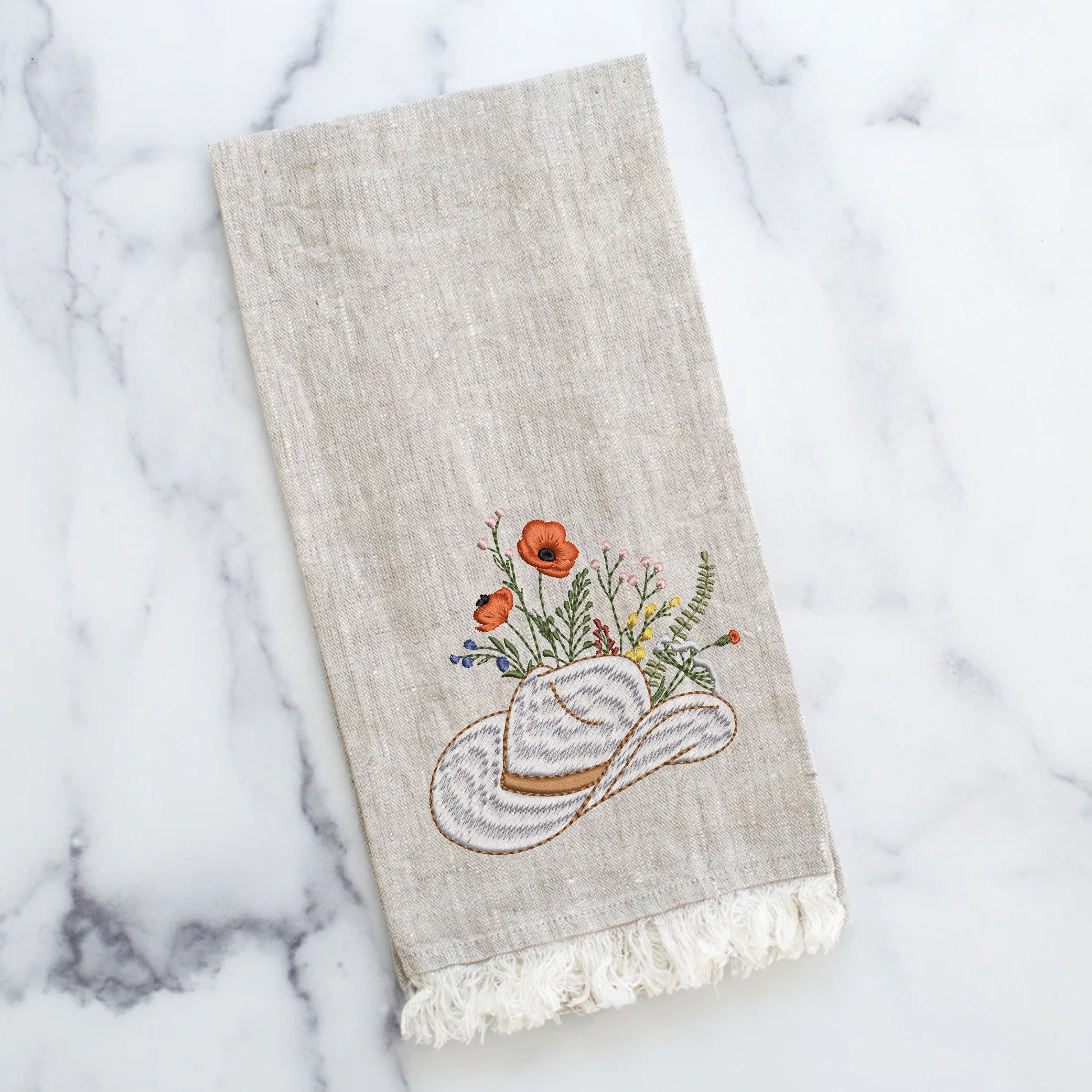 Cowgirl Wildflower Hat Machine Embroidery Design embroidered on a kitchen towel