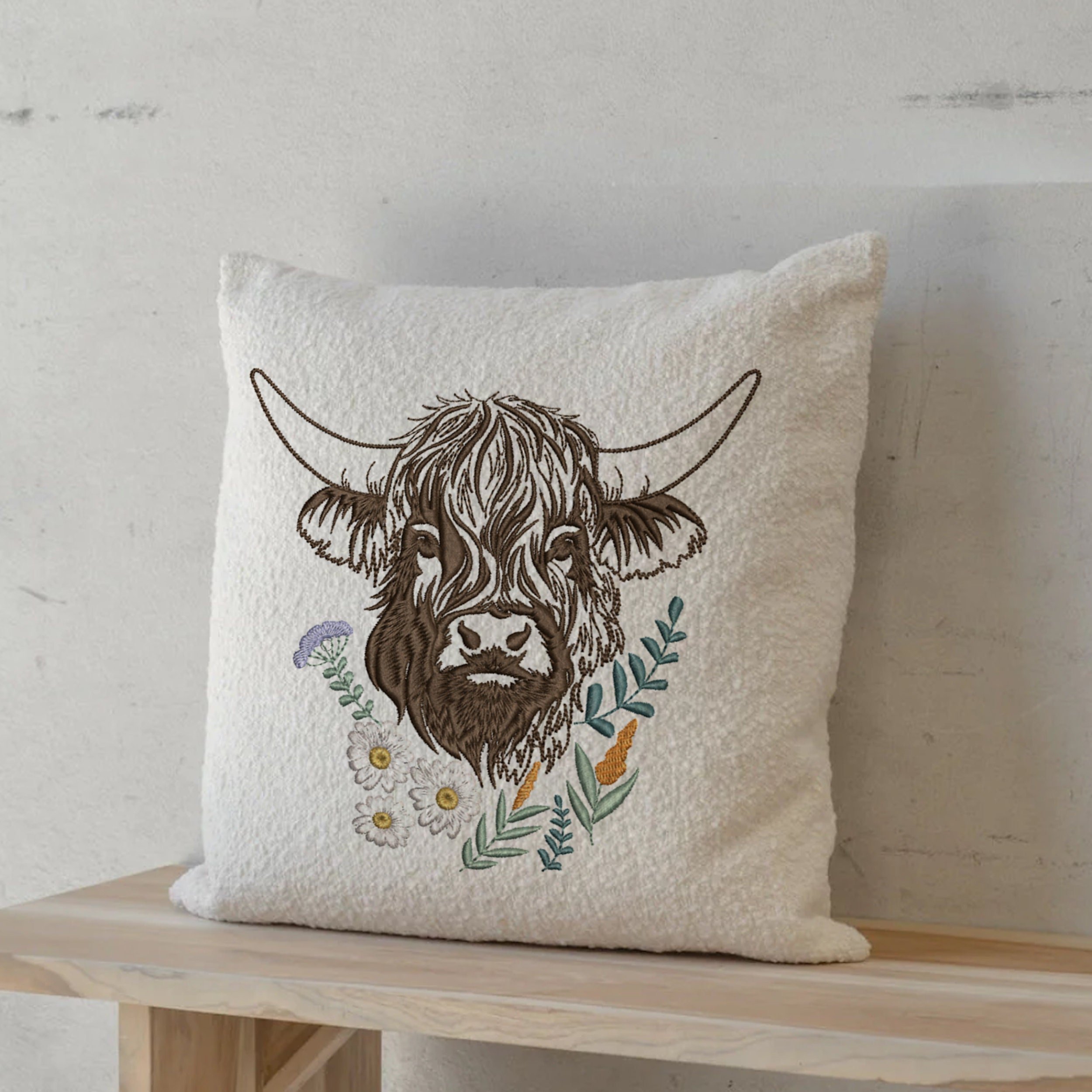 Highland Scottish Cow and Chamomiles Machine Embroidery Design File embroidered on a farmhouse pillow